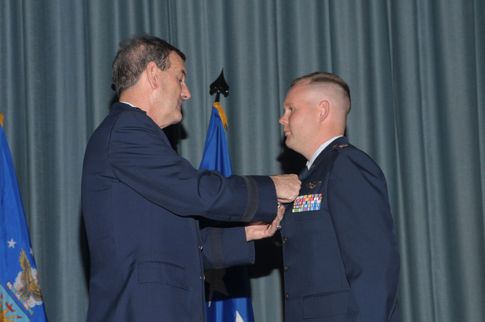 Gen. Stephen R. Lorenz (left) commander of Air Education and Training Command at Randolph Air Force Base, Texas, presents a Purple Heart to Capt. David Golden, 562nd Flying Training Squadron, during a ceremony at the base Sept. 1.  Captain Golden, who had been deployed as an electronic warfare officer to Forward Operating Base Orgun-E in eastern Afghanistan, considers himself lucky because the rocket attack on Sept. 28 could have been much more tragic for him and the members of the mortar squad. He suffered lacerations to his forehead after shrapnel glanced off the glass of his ballistic eyewear; the others suffered more severe injuries, but eventually returned to duty. (U.S. Air Force photo/Joel Martinez)
