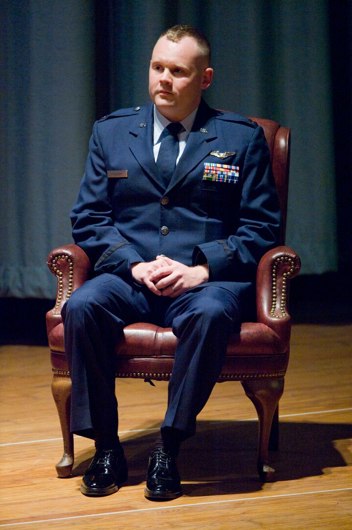 Capt. David Golden, 562nd Flying Training Squadron Instructor, Randolph Air Force Base, Texas, listens as Gen. Stephen R. Lorenz, Commander, Air Education and Training Command provides opening remarks during a ceremeony in which Golden was awarded the Purple Heart for lacerations to his forehead after shrapnel glanced off the glass of his ballistic eyewear while deployed as an Electronic Warfare Officer to Forward Operating Base Orgun-E. (U.S. Air Force photo/Steve Thurow)