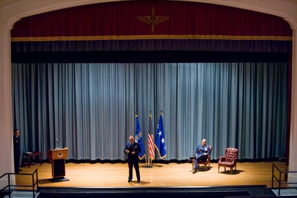 Capt. David Golden, 562nd Flying Training Squadron Instructor, Randolph Air Force Base, Texas, recounts the day he received lacerations to his forehead after shrapnel glanced off the glass of his ballistic eye wear while deployed as an Electronic Warfare Officer to Forward Operating Base Orgun-E to fellow members of the 562th FTS in attendance for Golden's Purple Heart award ceremony which was presided over by Gen. Stephen R. Lorenz (right), Air Education and Training Command, Commander. (U.S. Air Force photo/Steve Thurow)