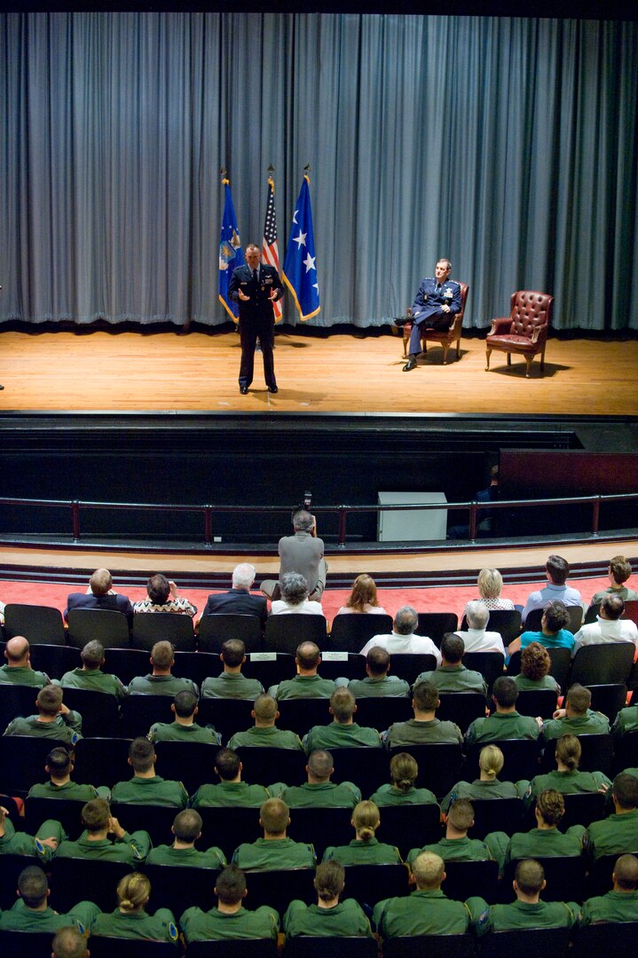 Capt. David Golden, 562nd Flying Training Squadron Instructor, Randolph Air Force Base, Texas, recounts the day he received lacerations to his forehead after shrapnel glanced off the glass of his ballistic eyewear while deployed as an Electronic Warfare Officer to Forward Operating Base Orgun-E to fellow members of the 562 FTS in attendance for Golden's Purple Heart award ceremony which was presided over by Gen. Stephen R. Lorenz (right), Air Education and Training Command, Commander. (U.S. Air Force photo/Steve Thurow)