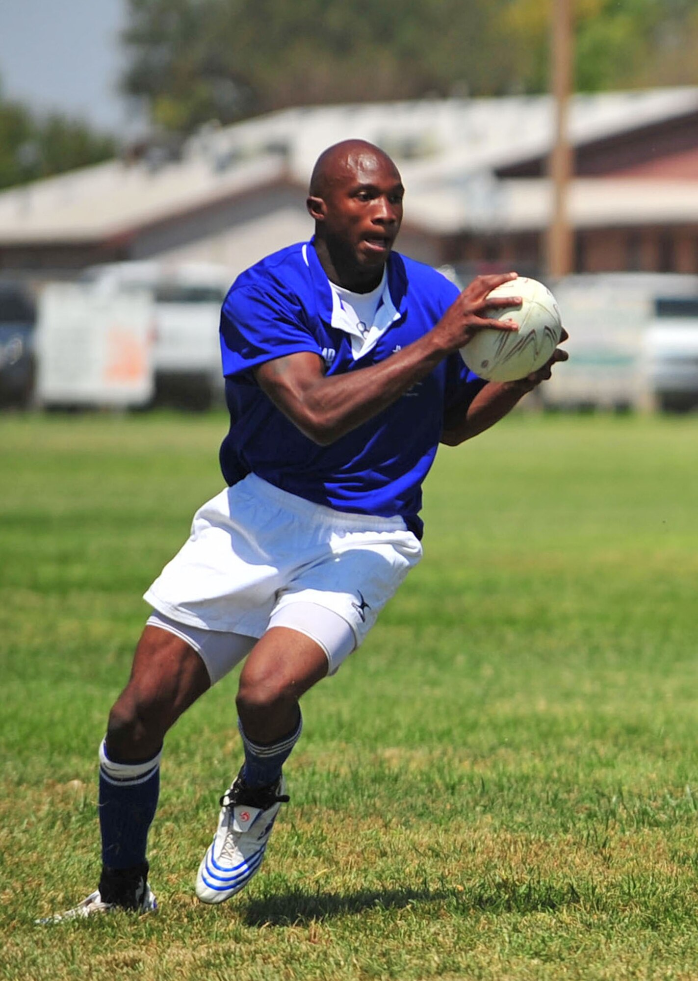 CLOVIS, N.M -- Airman First Class Joseph Stevens, 27th Special Operations Aircraft Maintenance Squadron, advances the ball during the Clovis Nomads rugby game Aug. 29.  Airman Stevens helped the Clovis team win their first game of the season against the New Mexico State University team from Las Cruces, N.M. Currently over 70 percent of the Clovis Nomads? team is made up Cannon Airmen. (U.S. Air Force photo by Staff Sgt. Heather R. Redman/RELEASED)