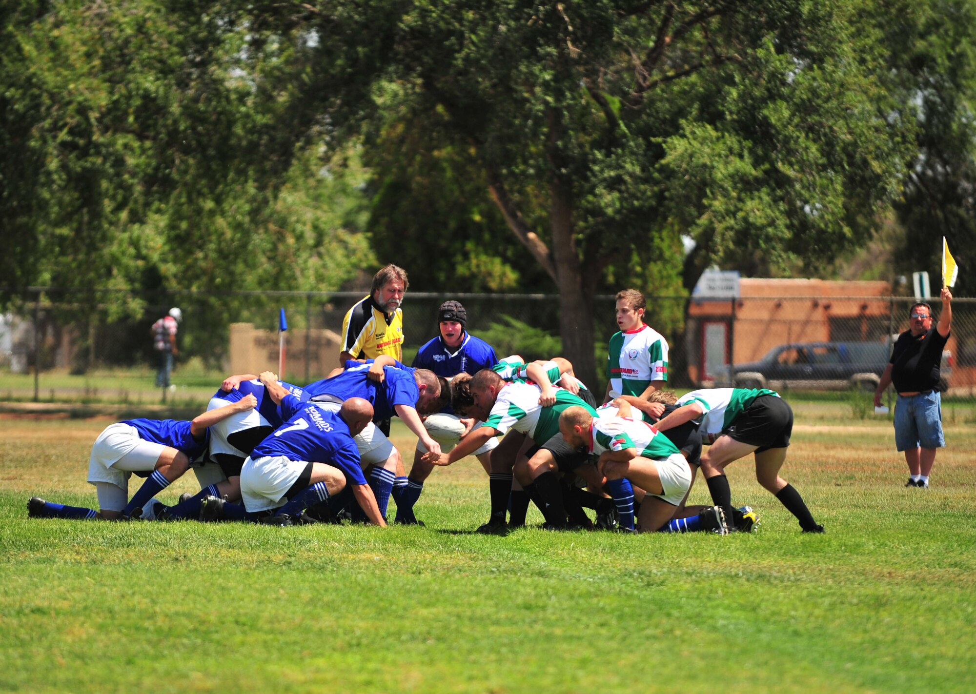 CLOVIS, N.M--The Clovis Nomads (blue) and the Las Cruces Chiles (green) form a scrum during the opening season game in Clovis, N.M. Aug. 29. A scrum is a commonly used after one team loses the ball during a tackle or a fumble and the ball is not picked up by the other team. The Clovis Nomads went on to beat the Las Cruces Chiles 25-0. (U.S. Air Force photo by Staff Sgt. Heather R. Redman/RELEASED)