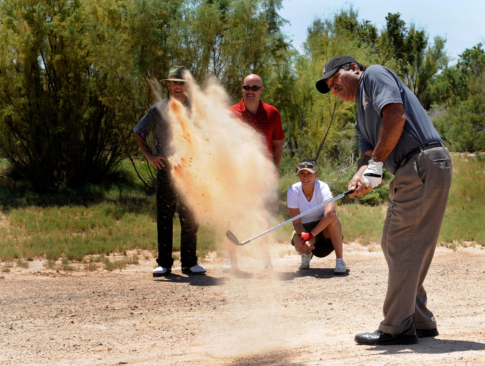 HOLLOMAN AIR FORCE BASE, N.M. -- Vaiee Teofilo, Apache Mesa Golf Course assistant manager, hits a golf ball during a golf tournament here Aug. 27. The tournament was sponsored by the Chief's Group as a fundraiser for the quality of life initiatives around base. (U.S. Air Force photo by Senior Airman Tiffany Trojca)