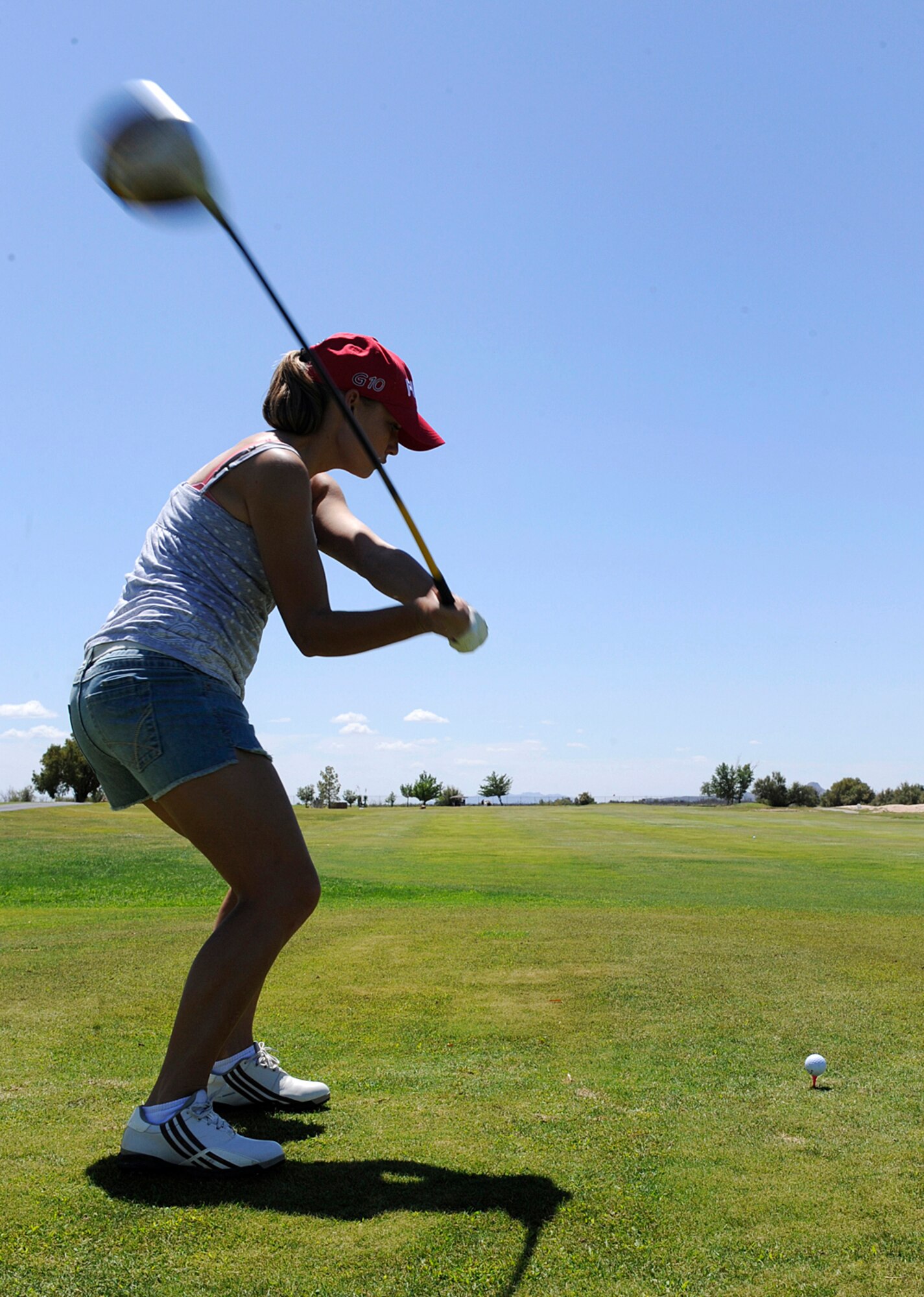 HOLLOMAN AIR FORCE BASE, N.M. -- Senior Airman Jenna Carpenter, 49th Civil Engineer Squadron firefighter, swings a club during a golf tournament here Aug. 27. The tournament was sponsored by the Chief's Group as a fundraiser to support the quality of life initiatives on base. (U.S. Air Force photo by Senior Airman Tiffany Trojca)