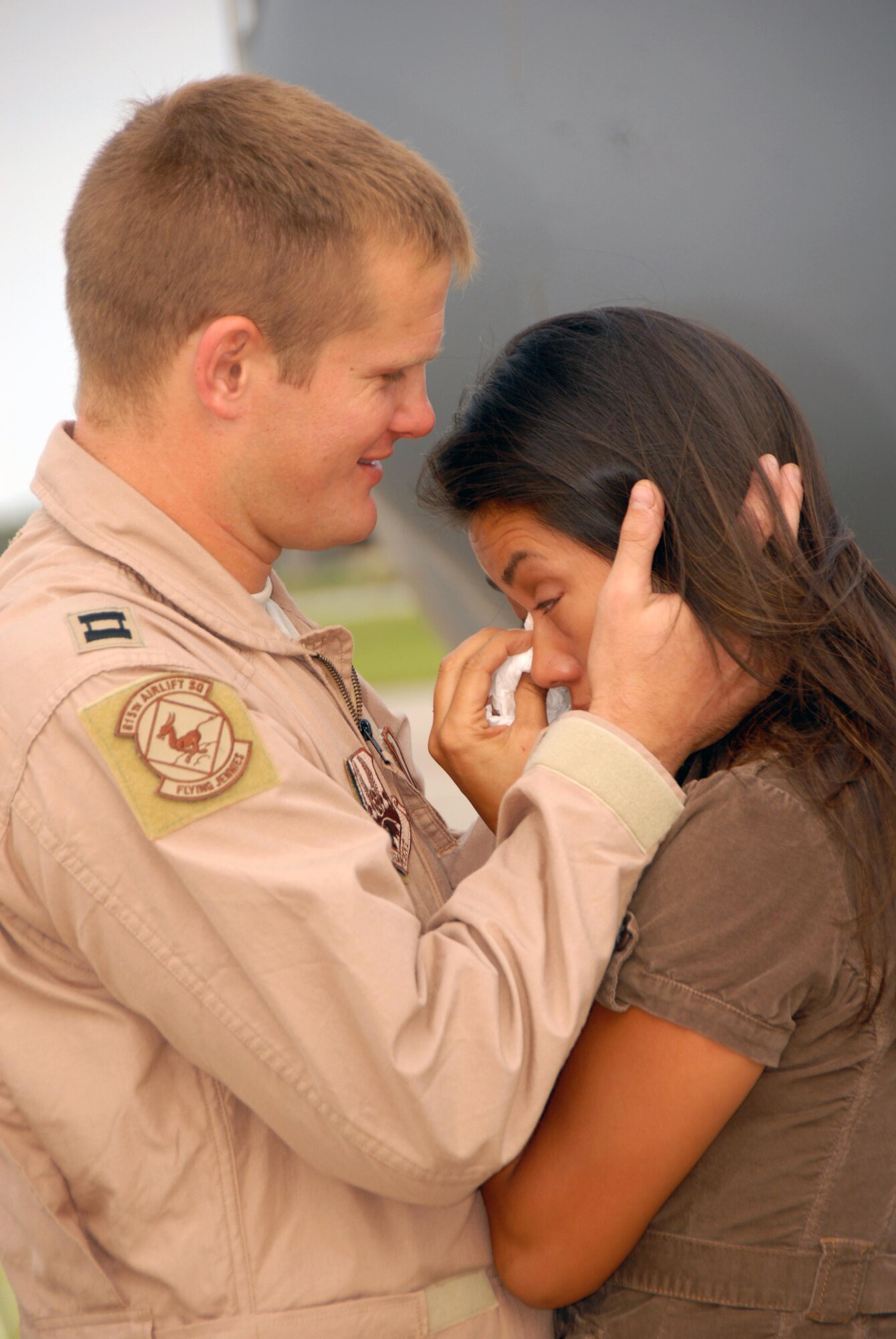 Family members of the 815th Airlift Squadron "Flying Jennies" bid farewell to their loved ones, who departed Keesler Air Force Base, Biloxi, Miss. Sept. 1 for their deployment to Southwest Asia. Among the second wave of deployers, Captain Dominic holds his wife in a tearful goodbye. He is one of nearly 105 Citizen Airmen deploying out of the 403rd Wing.
