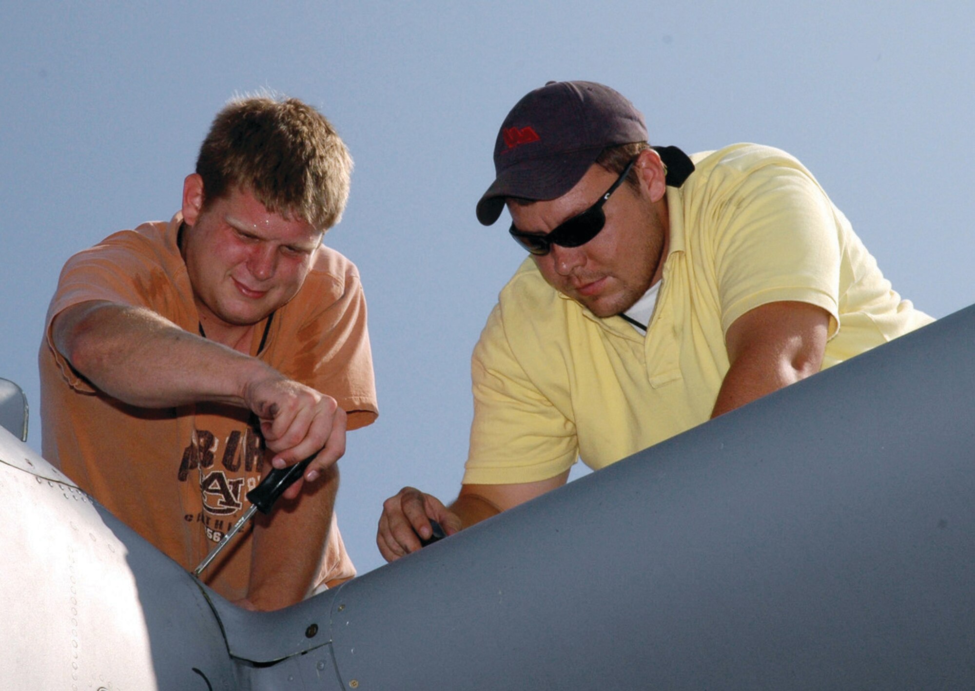 908th aircraft maintenance specialists Trey Garrison and Justin Proctor open a panel on a C-130 to perform an inspection. Garrison and Proctor are two beneficiaries of the new special pay rates authorized for the 908th Airlift Wing's wage-grade employees as of July 1. (U.S. Air Force photo/Lt. Col. Jerry Lobb)