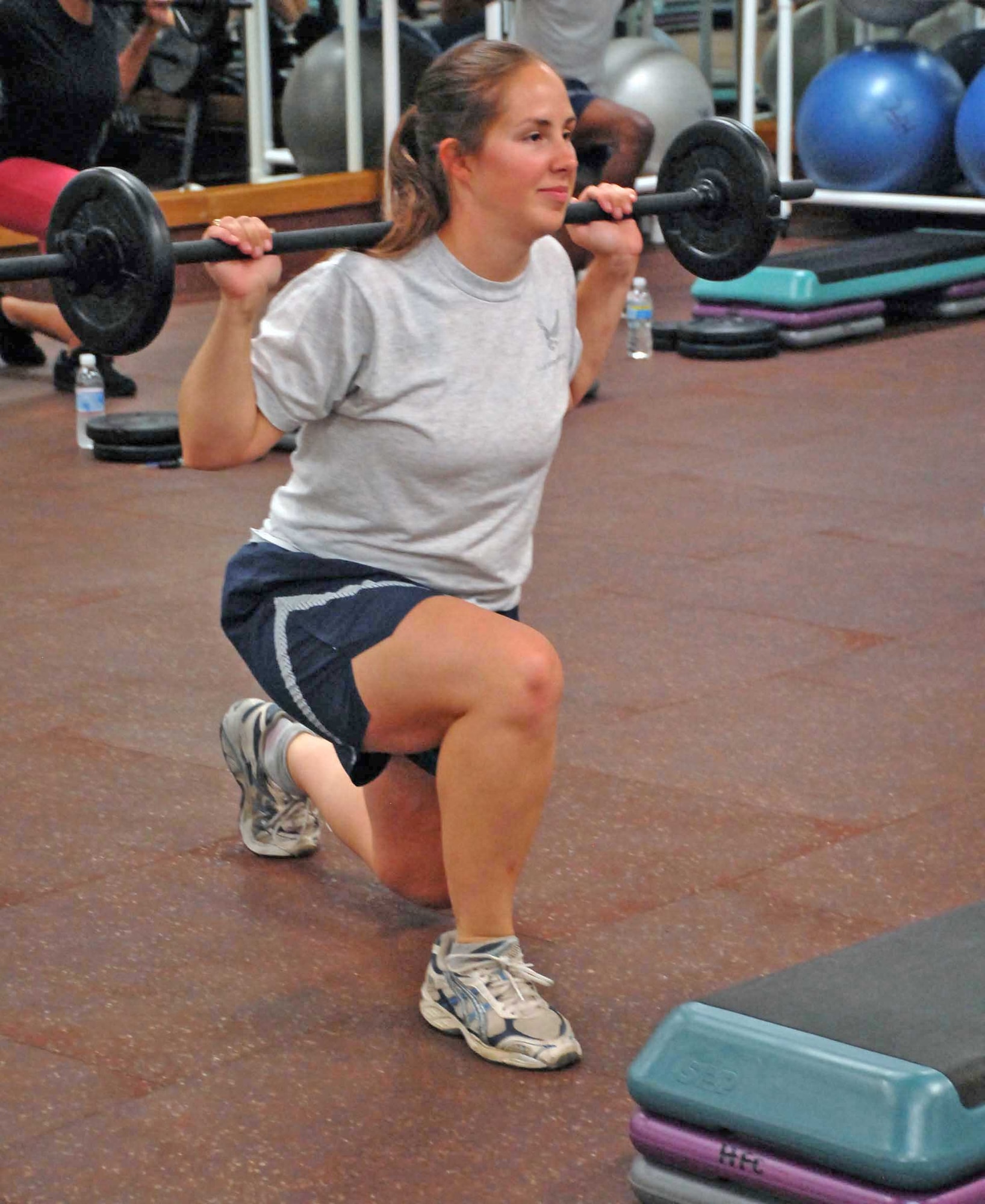 Second Lt. Melissa Croy does lunges during a workout Aug. 17, 2009, at the fitness center at Beale Air Force Base, Calif. Lieutenant Croy is one of the certified instructors for the new Body Pump program recently implemented to promote fitness at Beale.  (U.S. Air Force photo/Sandy Healy)