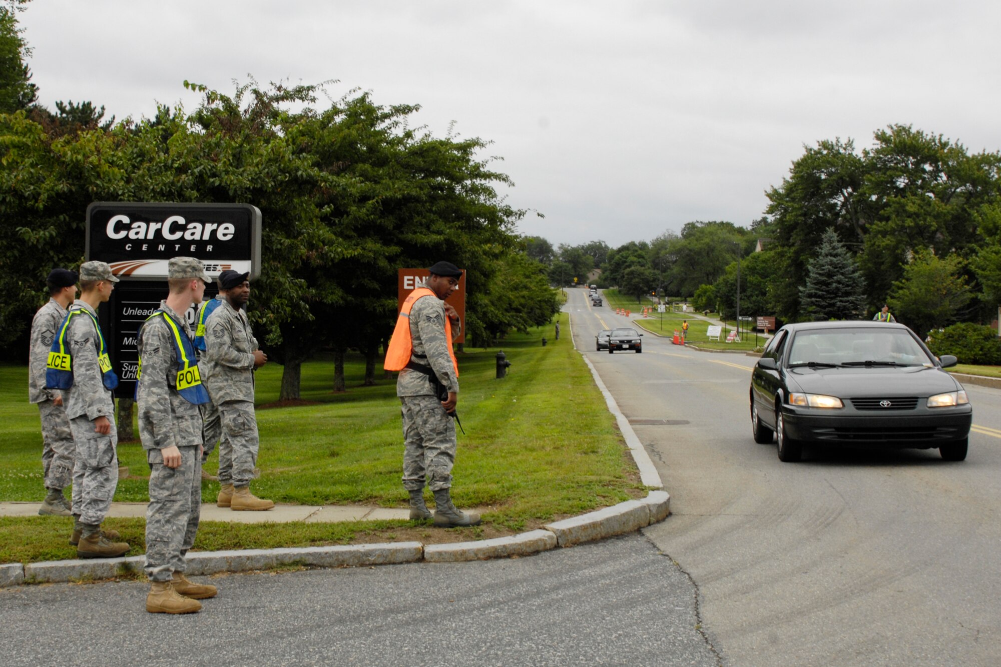 HANSCOM AIR FORCE BASE, Mass. - Right, Senior Airman Daniel Davis, 66th Security Forces Squadron patrolman, waves in oncoming Hanscom motorists committing traffic violations, such as using a cellular phone while driving or not wearing a seatbelt. 66 SFS positioned themselves on Barksdale Street to issue tickets to violators heading both directions. (U.S. Air Force photo by Linda LaBonte Britt)