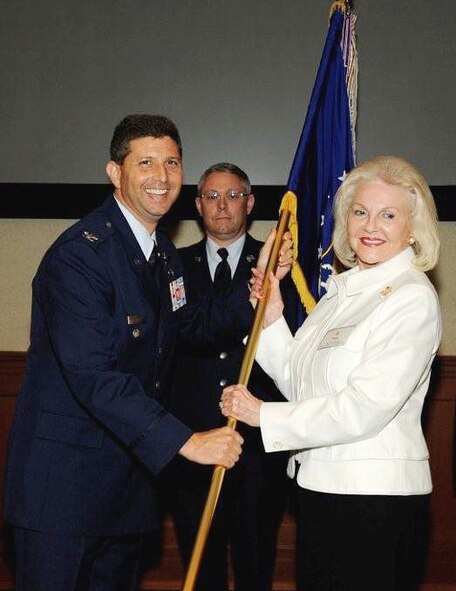Mrs. Vivian Reeves receives the 927th Air Refueling Wing flag from Vice Commander Colonel Theodore S. Mathews, Jr. (U.S. Air Force Photo/Staff Sgt. Joesph Swafford)