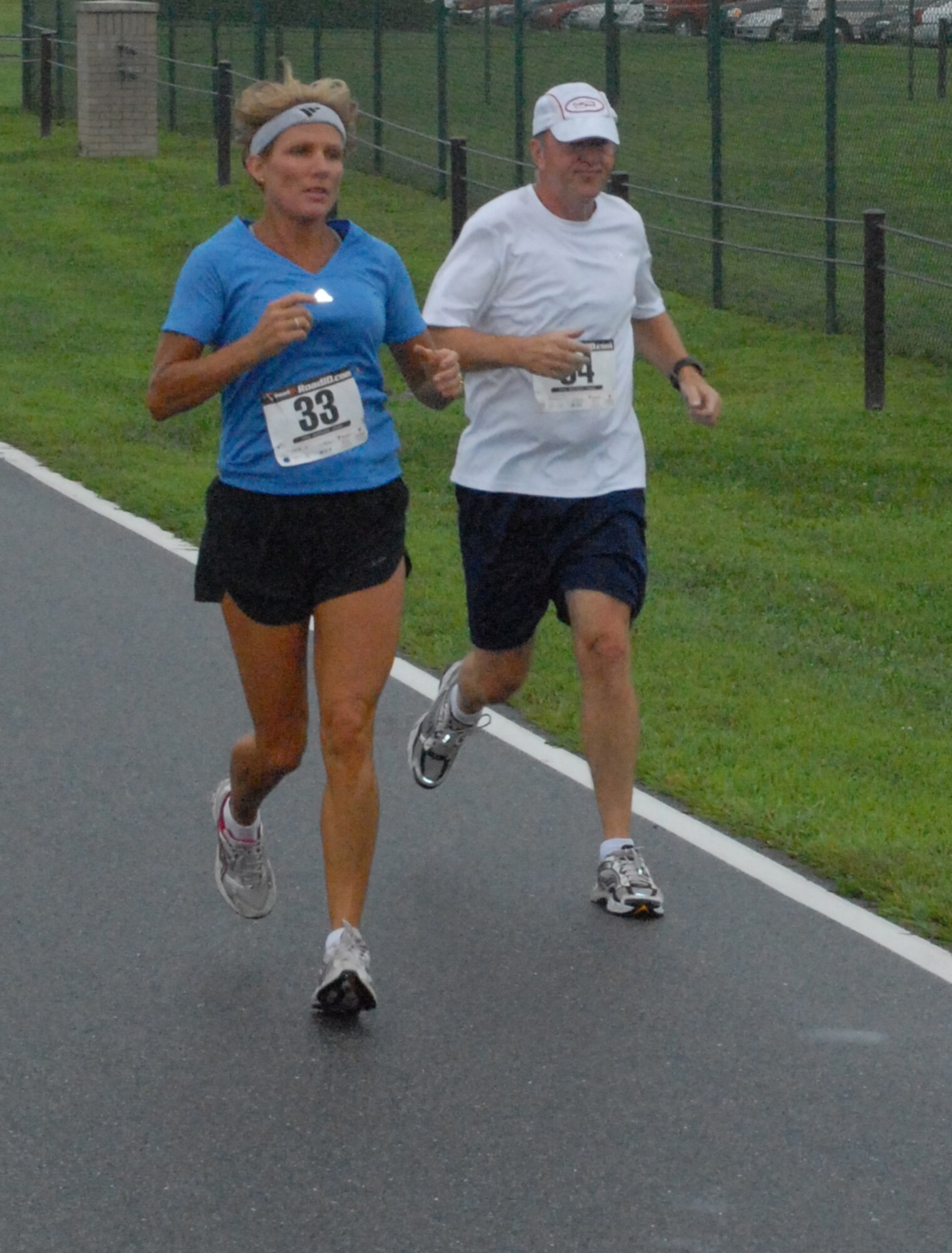 (left) Holly Scott and Joseph Rubacky participate in the ?Summer Sizzler,? Dover?s first 10-mile run Aug. 29.  Scott took 1st place in the female division with a time of 1:15:32.   (U.S. Air Force photo/Staff Sgt. Chad Padgett)