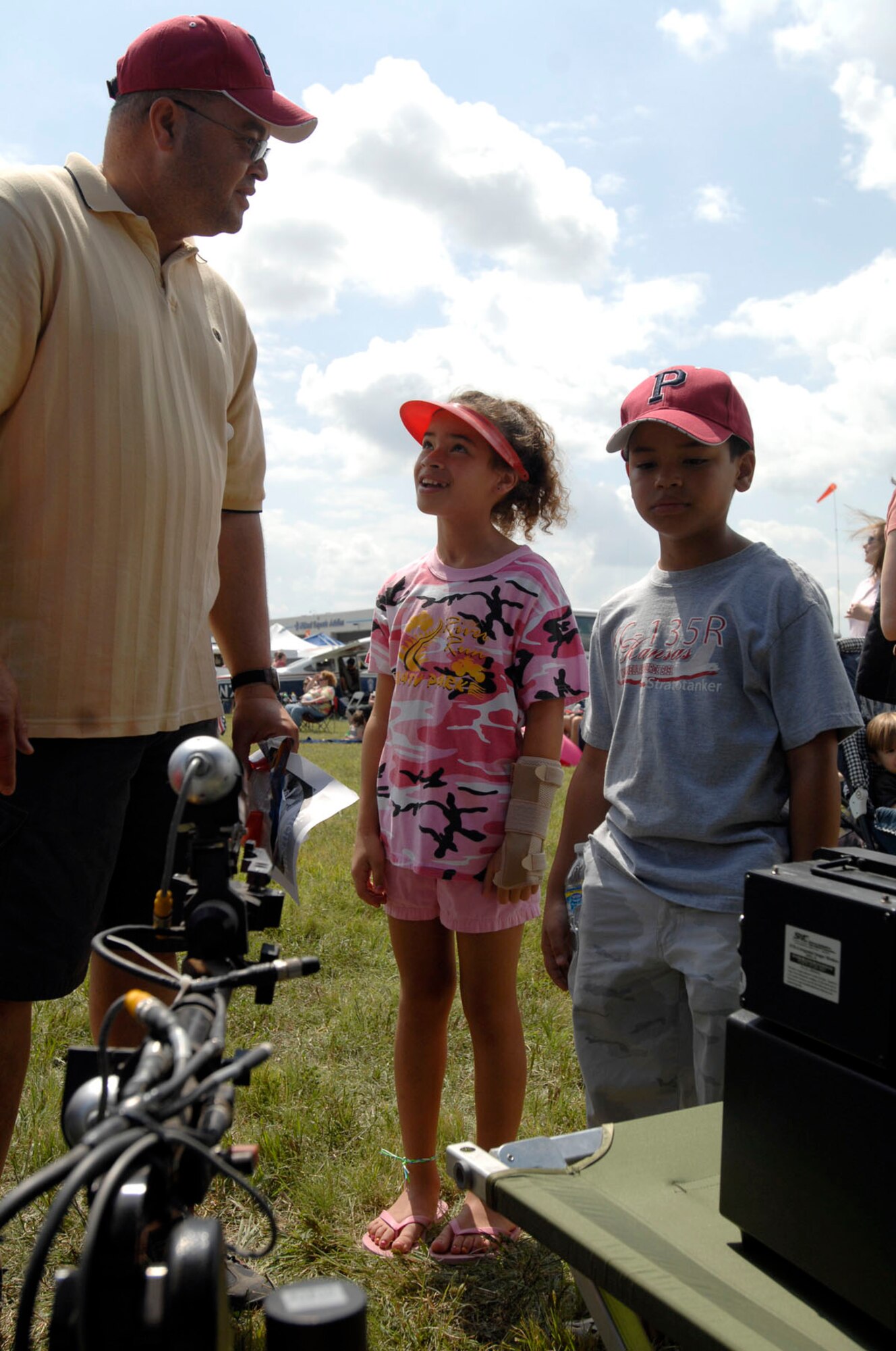 Tim Bynum, retired Air Force master sergeant, and children, Taylor, 10, and Zachary, 9, check out an explosive ordnance disposal robotic system Aug. 30, that helps EOD technicians safely move and dispose of explosives. Airmen from the 22nd Civil Engineer Squadron EOD unit, the 22nd Security Forces Squadron military working dog unit and the base honor guard performed demonstrations at the Wichita Flight Festival at the Colonel James Jabara Airport, Wichita, Kan.,  Aug. 29 to 30.  (U.S. Air Force photo by Senior Airman Jessica Lockoski)