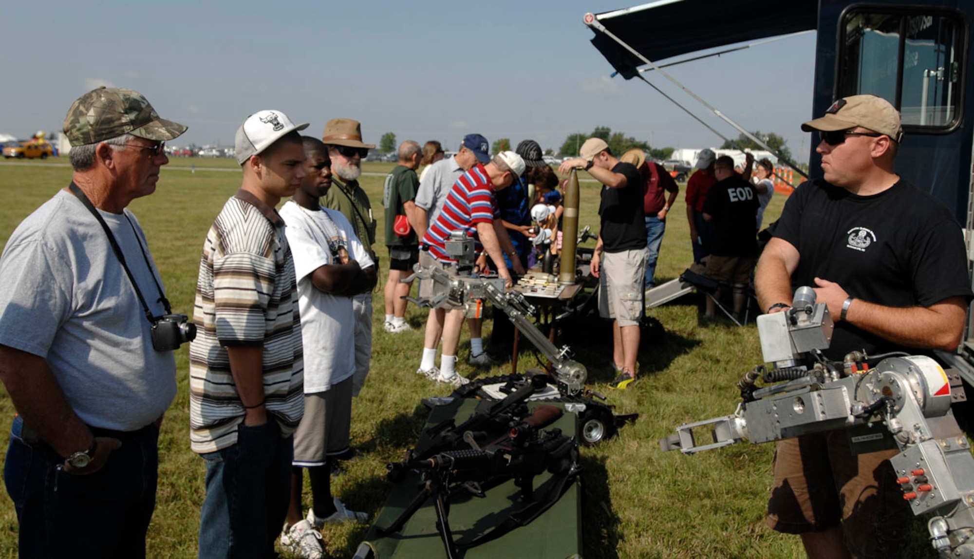 Tech. Sgt. Phillip Hauser, 22nd Civil Engineer Squadron Explosive Ordnance Disposal technician, talks to community members at the Wichita Flight Festival, at the Colonel James Jabara Airport, Aug. 29 about an EOD robot used to retrieve and detonate improvised-explosive devices.  EOD Airmen answered questions and showcased weapons they carry and use during overseas contingency operations, recovered inert munitions and a bomb suit.  (U.S. Air Force photo by Senior Airman Jessica Lockoski)