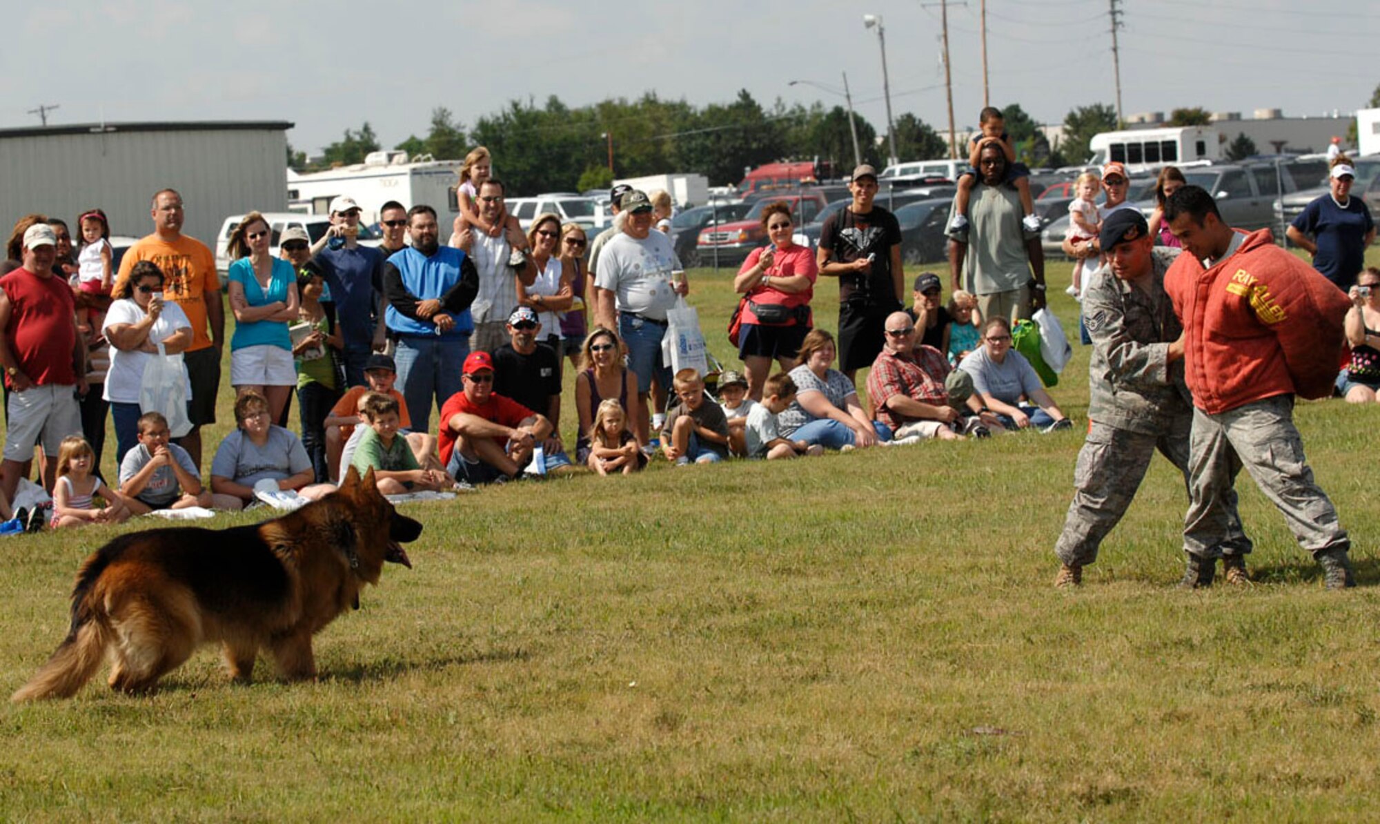 Staff Sgt. Max Soto, 22nd Security Forces Squadron military working dog handler, shouts voice commands at MWD, Atom, while “apprehending” Staff Sgt. Juan Garcia, 22nd SFS, during a MWD demonstration at the Wichita Flight Festival, Aug. 29, at the Colonel James Jabara Airport, Wichita, Kan. Security forces Airmen at McConnell use MWDs for patrol, drug and explosive detection and train with their handlers to provide support on base and world-wide contingency operations. (U.S. Air Force photo by Senior Airman Jessica Lockoski)