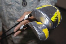 MINOT AIR FORCE BASE, N.D. -- Tech. Sgt. Robert Furbush, 5th Security Forces Squadron military working dogs noncommissioned officer-in-charge, shows off the set of two premium design golf clubs, a driver and a hybrid, sold during a fundraiser to help in the costs of treating lung cancer for a fellow Airman Aug. 31 here. A non-profit charity organization comprised of Warbirds and Rough Riders pulled together to support Senior Master Sgt. Michael Garrett, 5th Logistics Readiness Squadron fuels manager, and his wife, Judy. (U.S. Air Force photo by Airman 1st Class Benjamin Stratton)