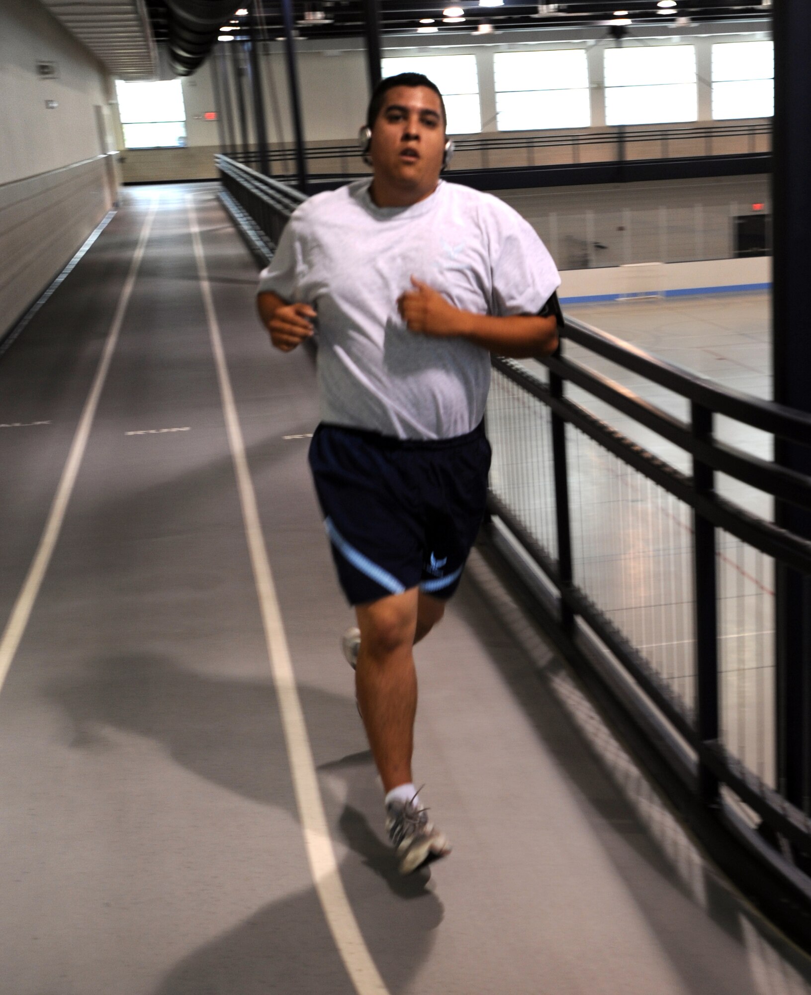 Staff Sgt. Joaquin Castro, 319th Logistics Readiness Squadron, runs along the track during the running portion of his fitness test Sept. 1 at the gym on Grand Forks Air Force Base, N.D. Sergeant Castro prepares himself for the new standards that will take effect Jan. 1, 2010. (U.S. Air Force photo by Staff Sgt. Suellyn F. Nuckolls)