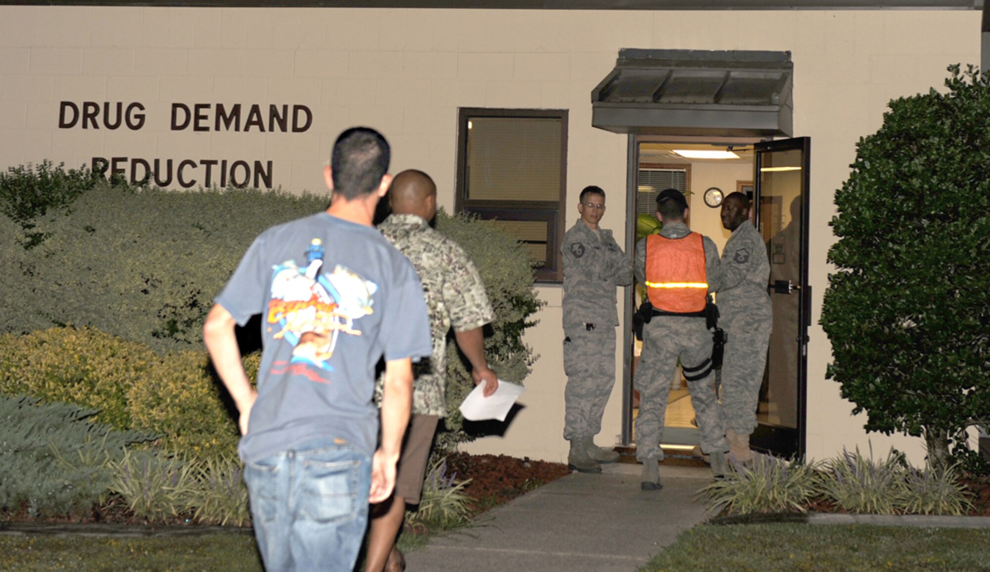 Members of the 4th Security forces squadron escort servicemembers into the Drug Demand Reduction Center to provide a urine sample for drug testing on Seymour Johnson Air Force Base, N.C., Aug. 29, 2009. Col. Mark Kelly, 4th Fighter Wing commander, ordered all servicemembers entering the main gate during a specified time had to report directly to the Drug Demand Reduction Center for urinalysis. (U.S. Air Force photo by Airman 1st Class Gino Reyes)