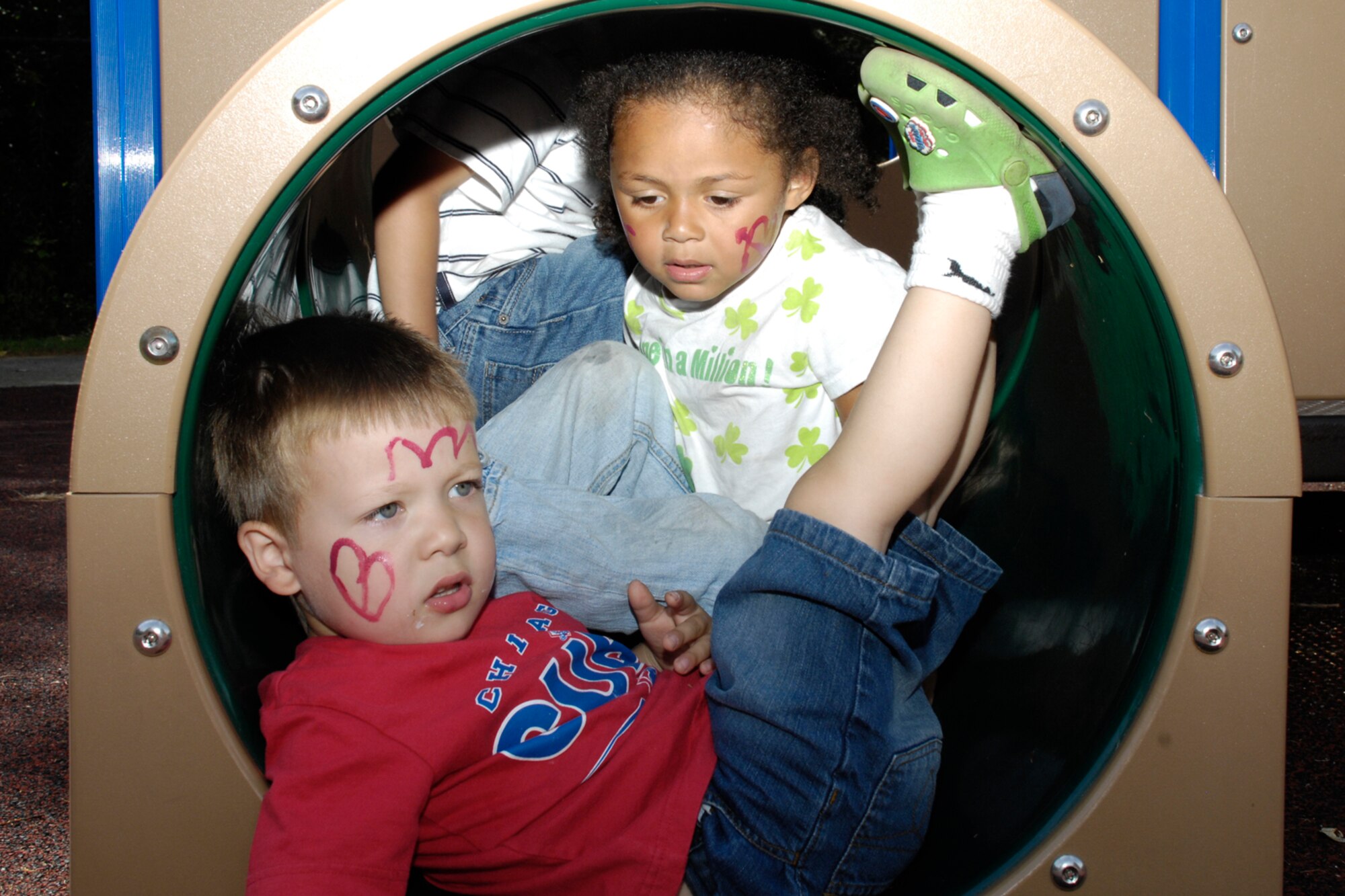 HANSCOM AIR FORCE BASE, Mass. – Liam Mackessy (front) and Alani Gonzalez (back) lounge in one of the climbing tubes on the Child Development Center playground, Aug. 25 during the Center’s annual summer carnival.  (U.S. Air Force photo by Linda LaBonte Britt)