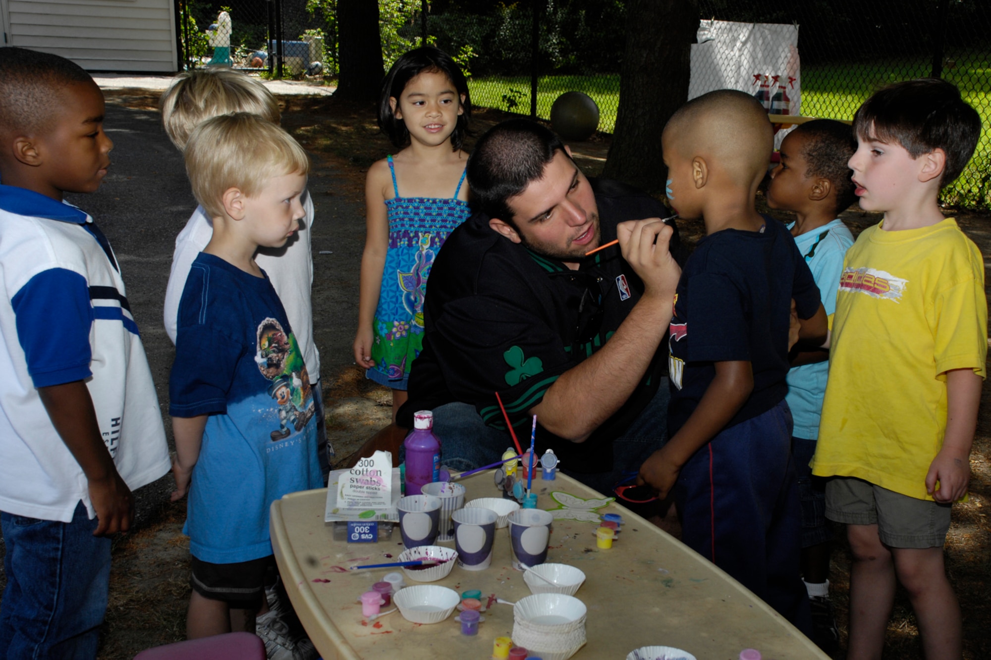 HANSCOM AIR FORCE BASE, Mass. –Children at Hanscom’s Child Development Center watch as one of their classmates gets his face painted during the Center’s summer carnival on Aug. 25.  (U.S. Air Force photo by Linda LaBonte Britt)