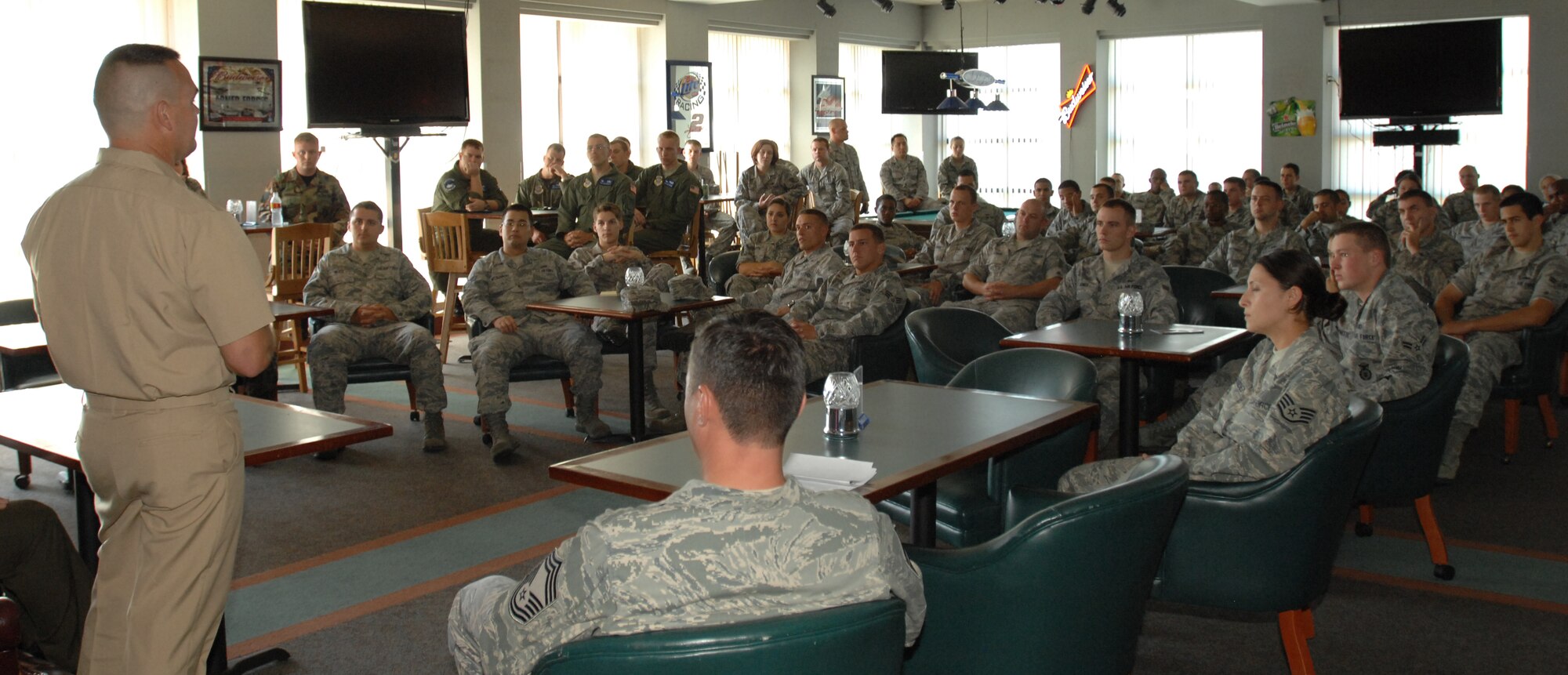 Navy Chief Hospital Corpsman Michael Musset, Marine Gunnery Sgt. Dustin Stalter,4th Maintenance Battalion, Wichita Marine Corps Reserve Training Center, and Army Sgt. 1st Class Richard Owen, Wichita Army Recruiting Company, speak to a group of Airmen at McConnell Air Force Base, Kan., Aug. 25, during a professional seminar at the Storm Cellar. Chief Musset, Sergeant Stalter and Sergeant Owen briefed Airmen on the difference in experiences and traditions within the Army, Navy and Marines. (U.S. Air Force photo/ Staff Sgt. Jamie Train)