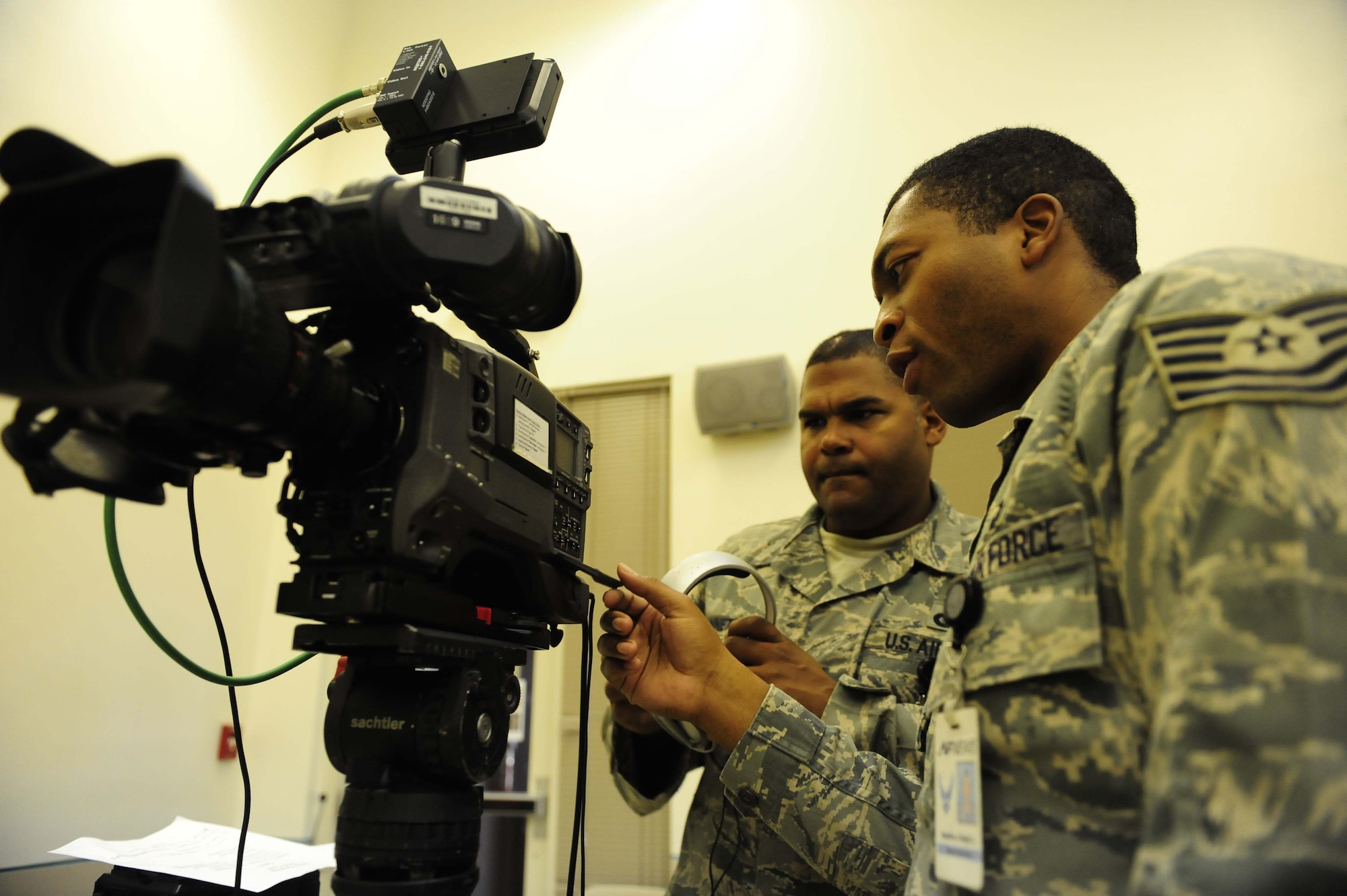 Staff Sgt. James Zannetti (left) goes over camera techniques and composition with holiday greetings veteran Tech. Sgt. Dwight Hawkins Aug. 27, 2009, during preparations for the taping of video holiday greetings at more than 60 locations worldwide.  The two NCOs are broadcasters with the Joint Hometown News Service in San Antonio.  (U.S. Air Force photo/Senior Airman Christopher Griffin)