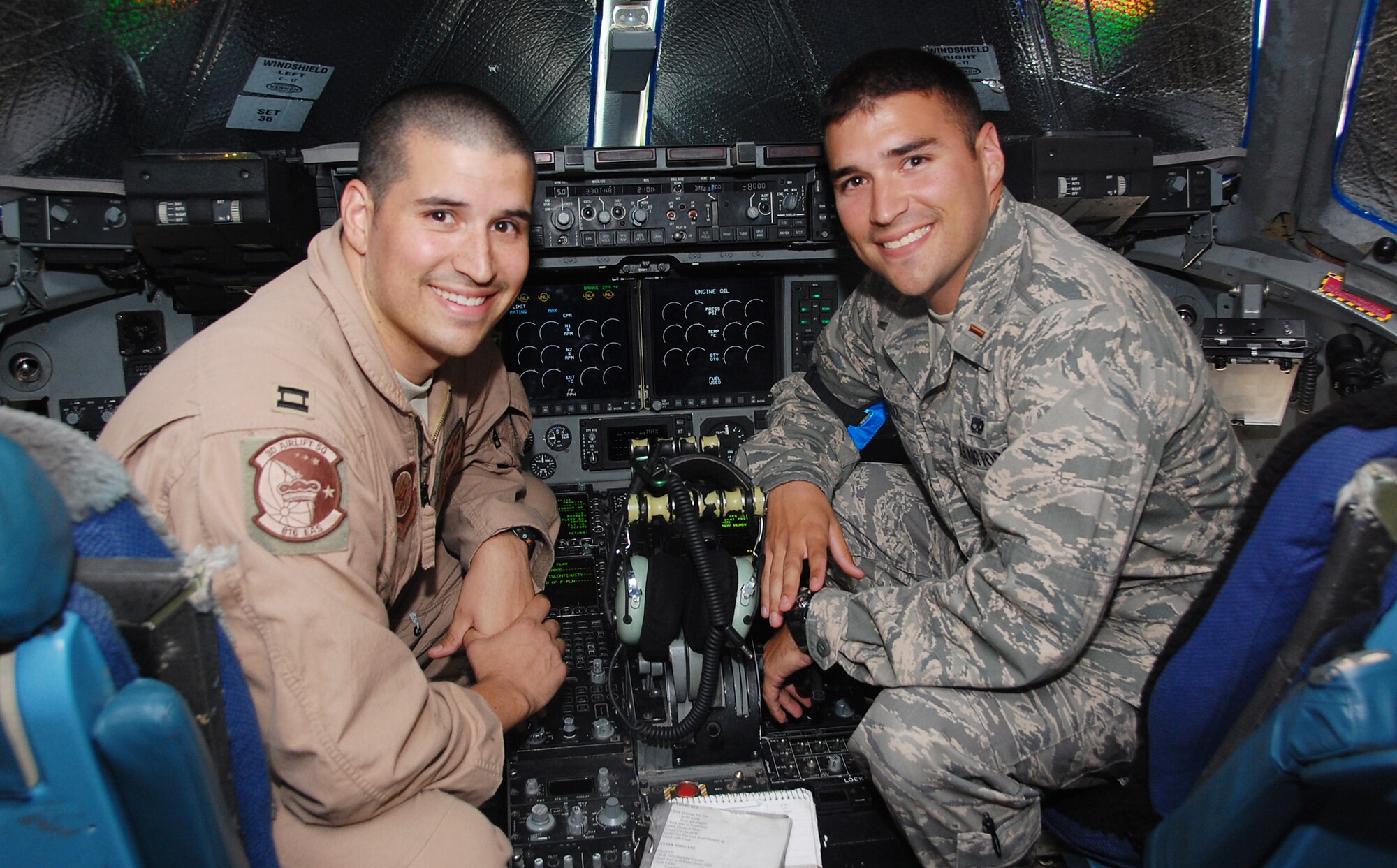 Capt. Bryan Lucero (left) and his younger brother 2nd Lt. Nathan Lucero are deployed together at an air base in Southwest Asia. As an aircraft maintenance officer, it is Lieutenant Lucero's job to ensure his brother's aircaft are fit to fly. Lieutenant Lucero is the 5th Expeditionary Aircraft Maintenance Squadron officer in charge deployed from McChord Air Force Base, Wash., and Captain Lucero is an a 817th Expeditionary Airlift Squadron C-17 Globemaster III pilot deployed from Dover AFB, Del. The brothers hail from Albuquerque, N.M. (U.S. Air Force photo/Staff Sgt. Shaun Emery)