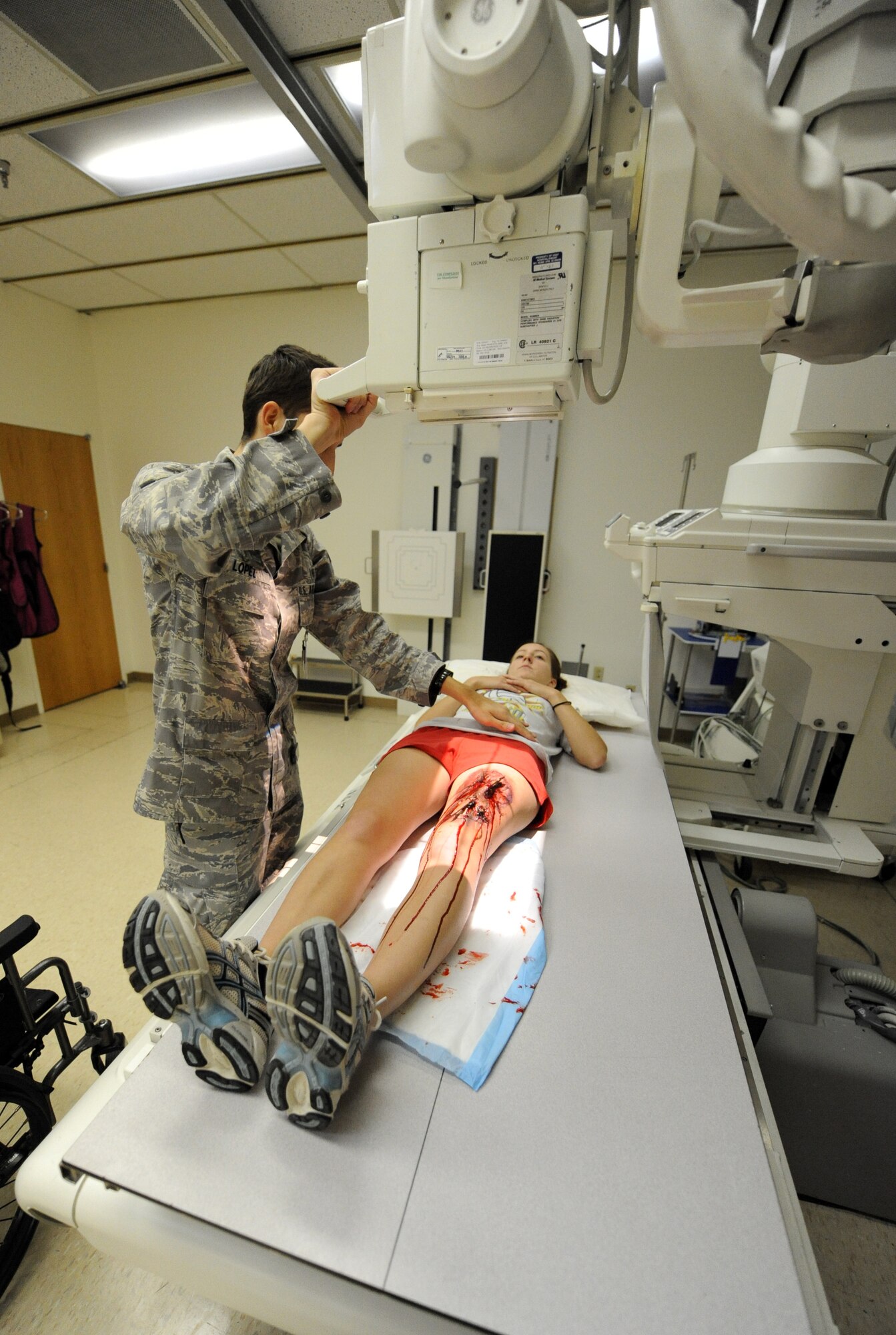 MOUNTAIN HOME AIR FORCE BASE, Idaho – Airman 1st Class Frederick Lopez, 366th Medical Operations Squadron radiology technician, takes a simulated x-ray of Airman 1st Class Amber Cripe, 366th Component Maintenance Squadron hydraulics apprentice, during an exercise Aug. 25. Moulage exercises enhance realism and allow first responders to practice self aid and buddy care while getting used to seeing injuries. (U.S. Air Force photo by Airman 1st Class Debbie Lockhart)