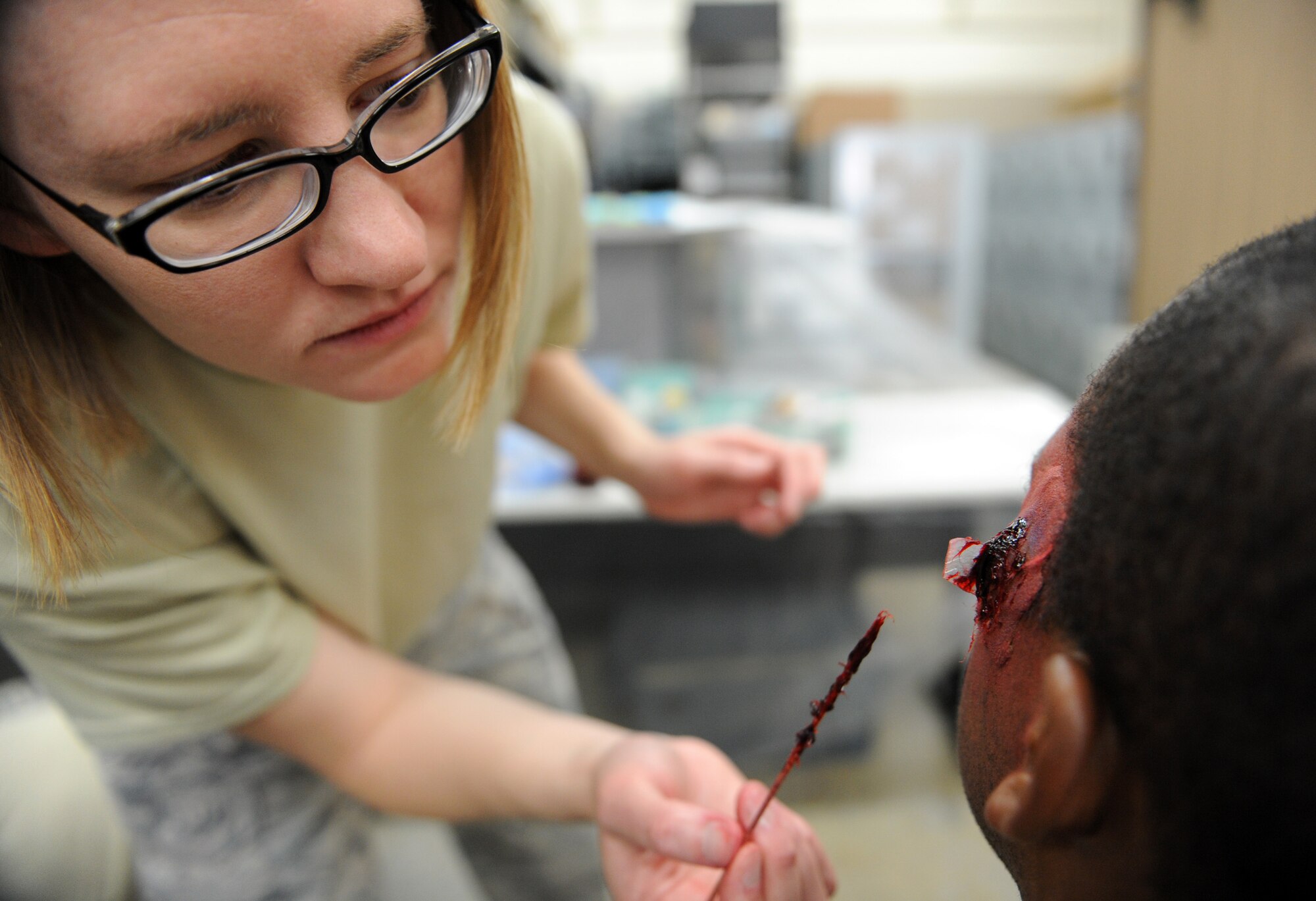 MOUNTAIN HOME AIR FORCE BASE, Idaho – Tech. Sgt. Grace Smiley, 366th Aerospace Medical Squadron noncommissioned officer in charge of community health, applies moulage makeup to Senior Airman Brandaun James, 366th Medical Group outpatient records journeyman, during an exercise Aug. 25. Moulage exercises enhance realism and allow first responders to practice self aid and buddy care while getting used to seeing injuries. (U.S. Air Force photo by Airman 1st Class Debbie Lockhart)
