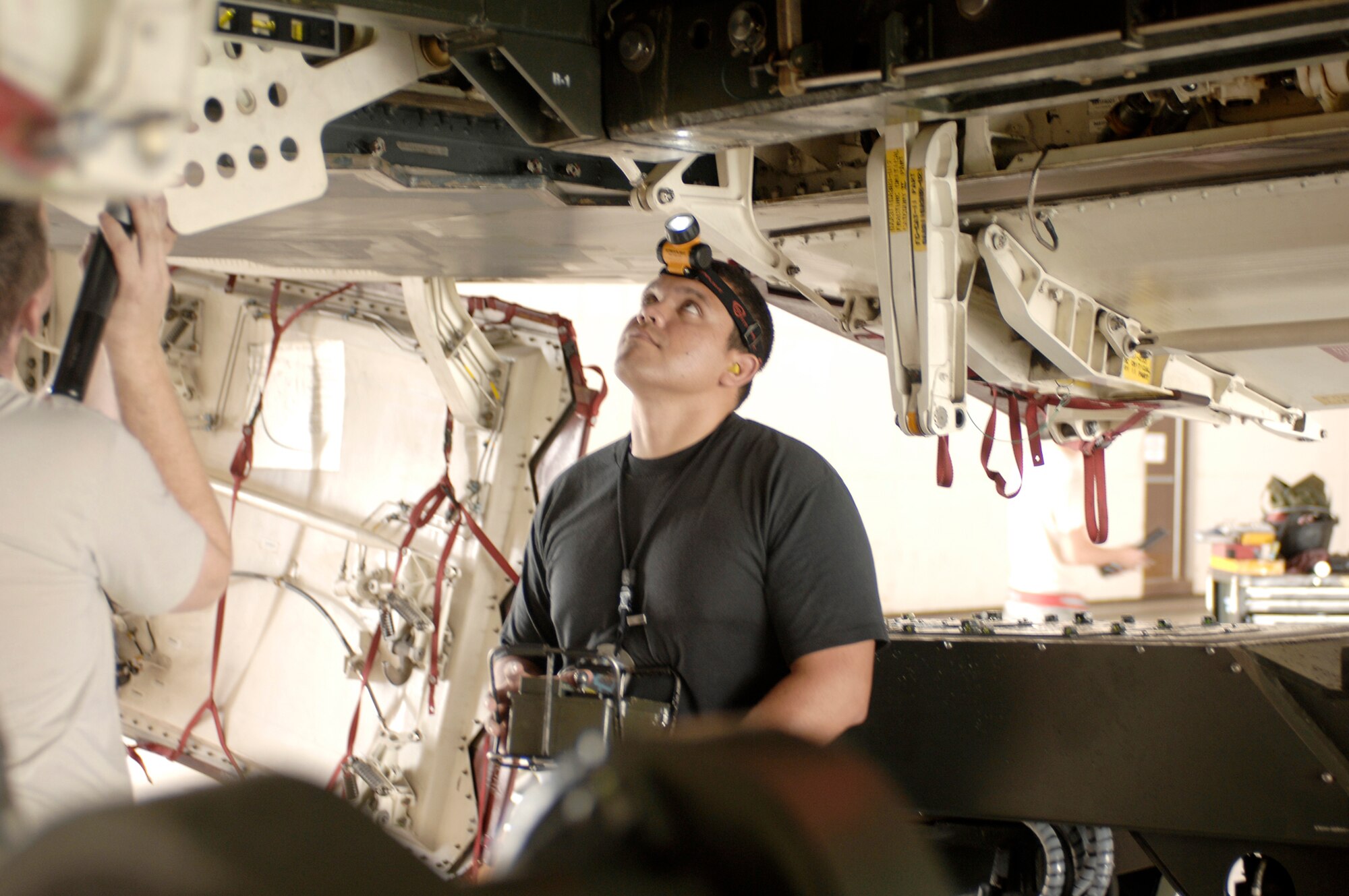 Staff Sgt. Juan Molina observes a weapons trailer position as he raises it into the bomb bay of a B-2 Spirit Aug. 17, 2009 at Whiteman Air Force Base, Mo. Mock bombs were loaded on the B-2 as part of the 72nd Test and Evaluation Squadron's Combat Sledgehammer evaluation. Sergeant Molina is assigned to the 509th Aircraft Maintenance Squadron. (U.S. Air Force photo/Staff Sgt. Jason Barebo)