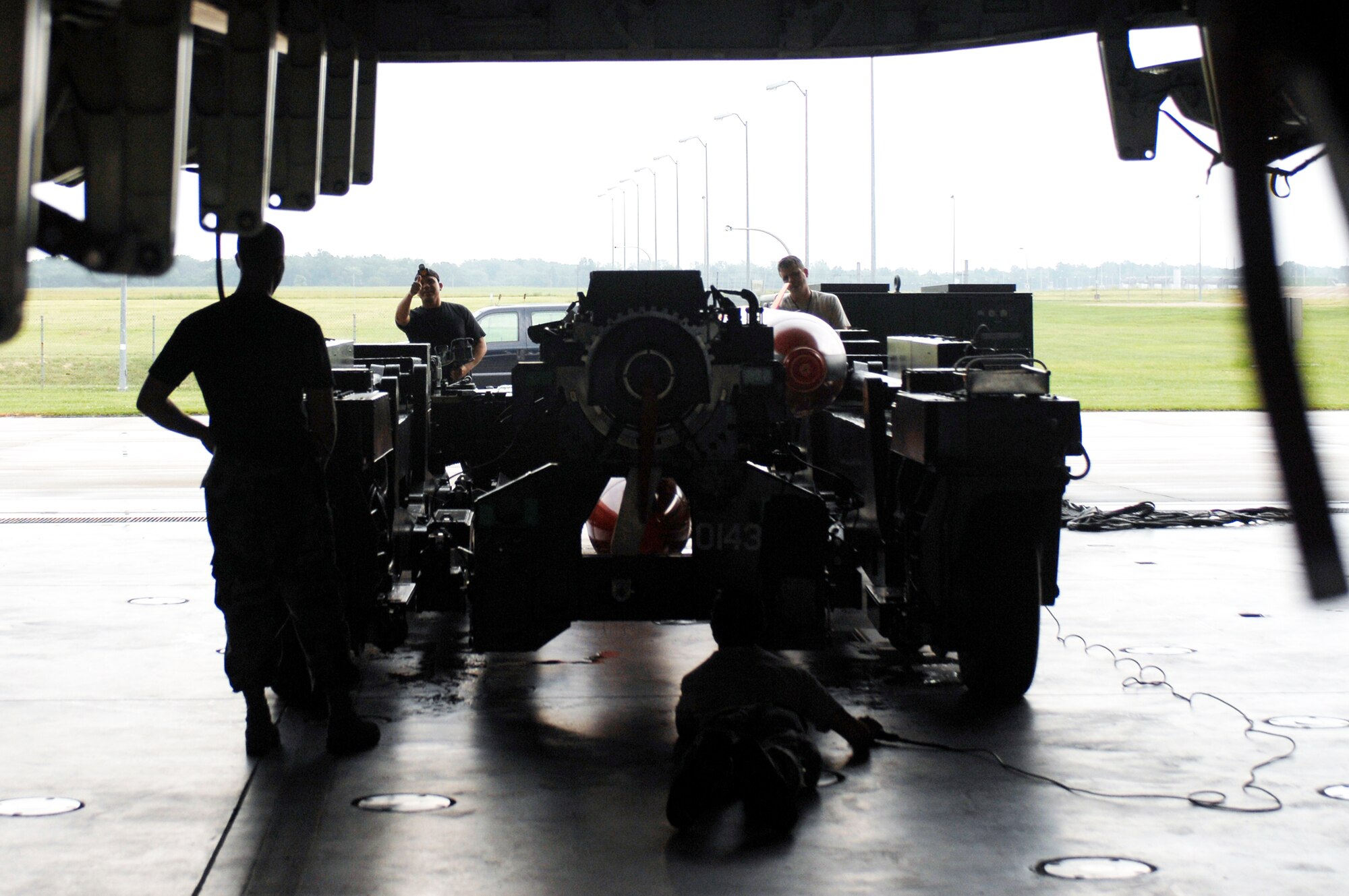 Members of a weapons load crew move a weapons load trailer into position under the bomb bay of a B-2 Spirit Aug. 17, 2009 at Whiteman Air Force Base, Mo. The weapons load is part of the 72nd Test and Evaluation Squadron's Combat Sledgehammer. (U.S. Air Force photo/Staff Sgt. Jason Barebo) 