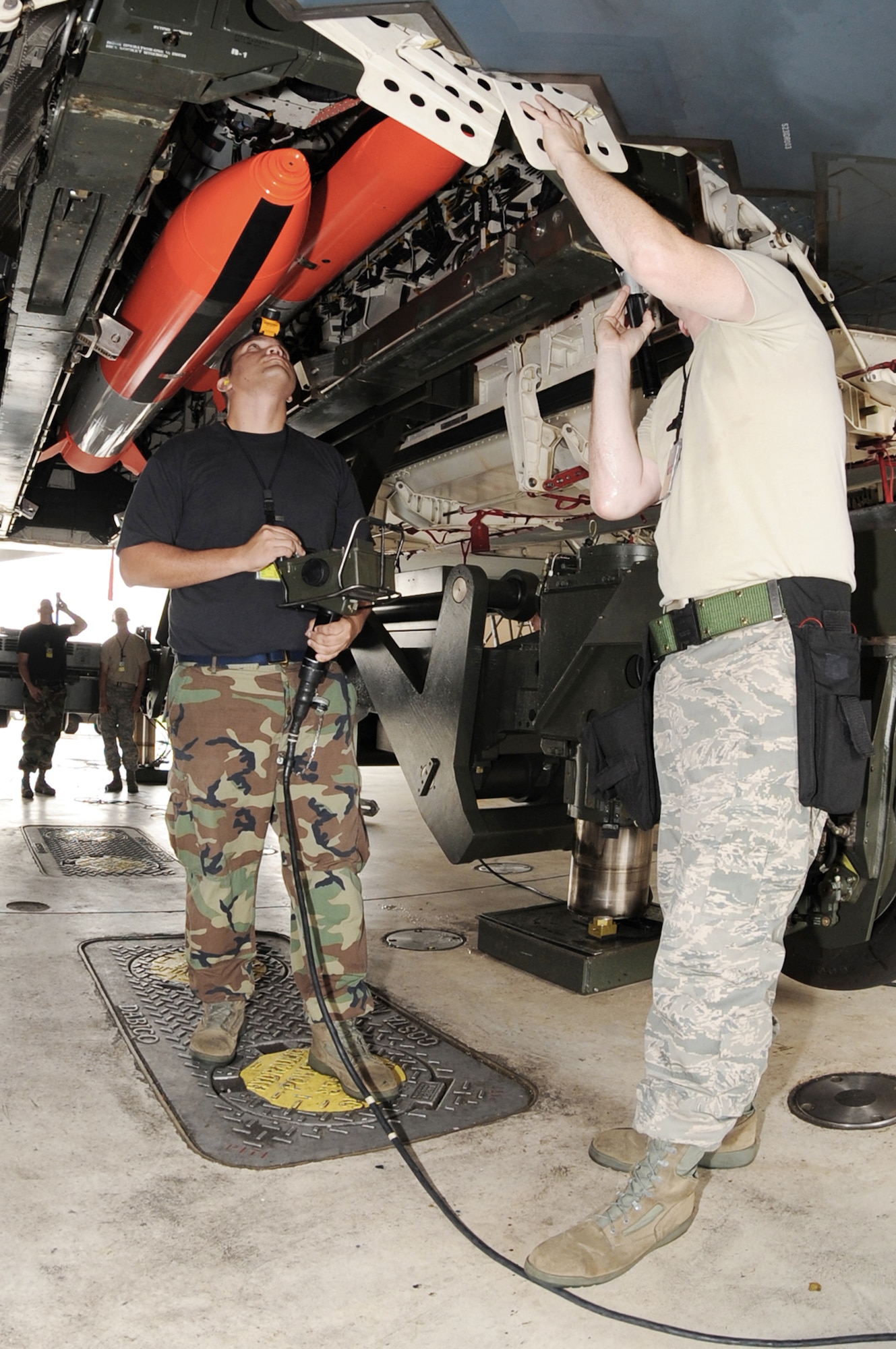 Tech. Sgt. Damen Cipolla inspects the rotary launch assembly as it's being lifted into a B-2 as Senior Airman Gregory Lowe runs the controls to lift the assembly into place Aug. 17, 2009 at Whiteman Air Force Base, Mo. This Inspection is one of the first inspections to fall under Air Force Global Strike Command since the command stood up. Sergeant Cipolla is assigned to the 509th Aircraft Maintenance Squadron. (U.S. Air Force photo/Airman 1st Class Carlin Leslie) 
