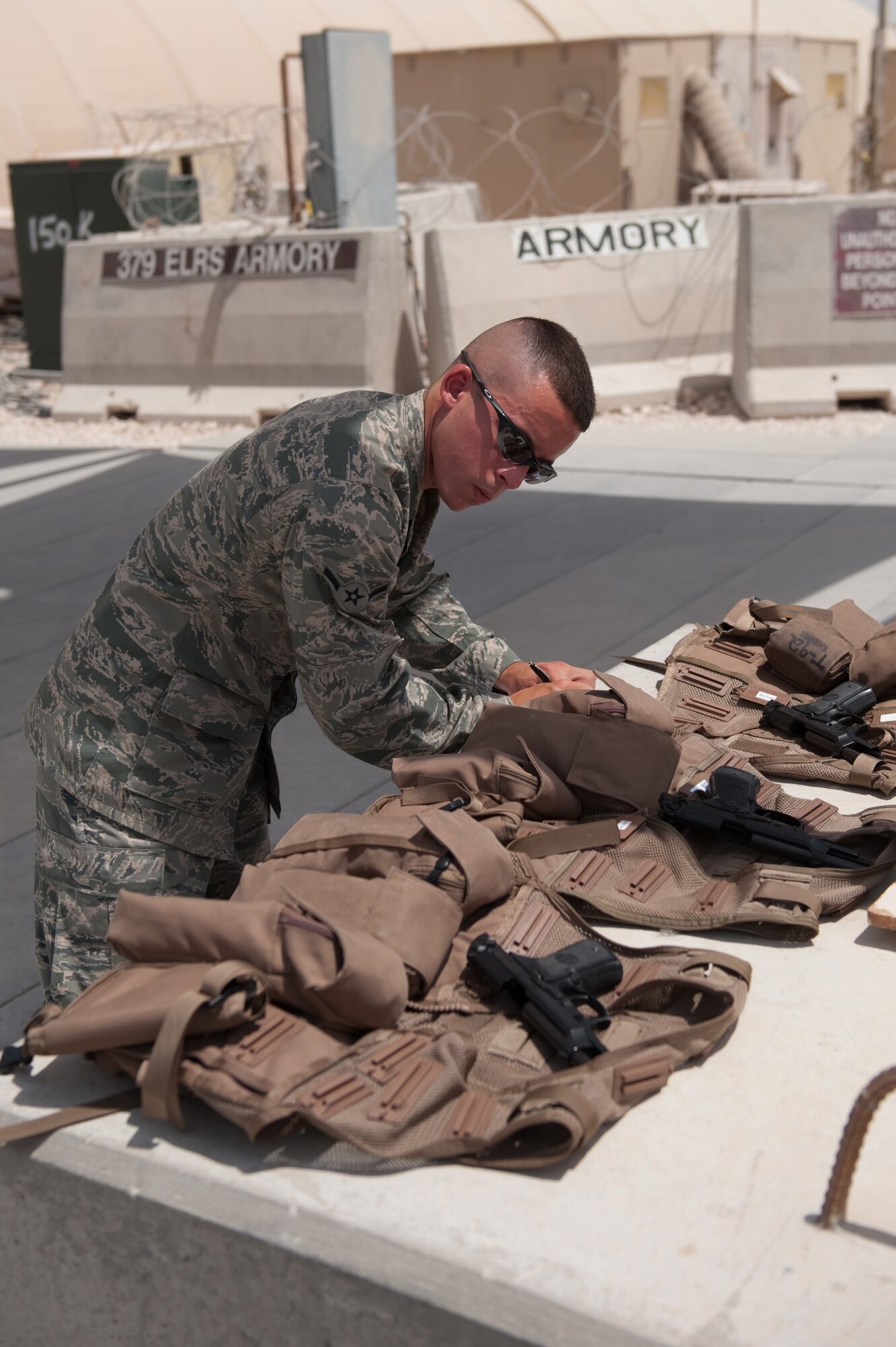 SOUTHWEST ASIA -- Airman Chad Labrie, 379th Expeditionary Operations Support Squadron aircrew flight equipment journeyman, prepares and checks aircrew survival vests, Aug. 28,Southwest Asia. Airman Labrie assists with the safety of aircrews by providing personal protective equipment and survival gear. Airman Labrie is deployed from Ellsworth Air Force Base, S.D. in support of Operations Iraqi Freedom and Enduring Freedom. (U.S. Air Force photo/Staff Sgt. Robert Barney)