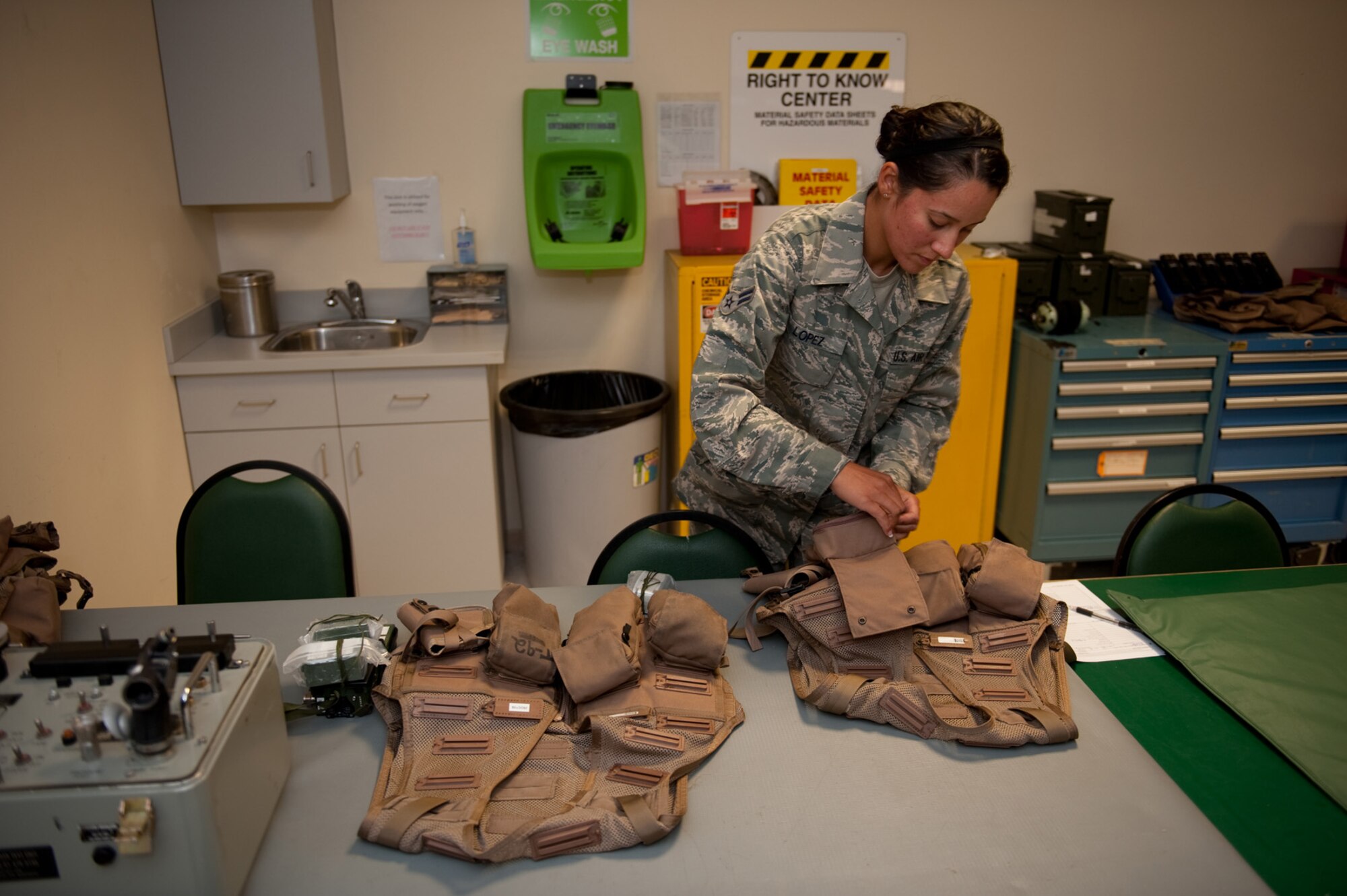 Airman 1st Class Jennifer Lopez, 379th Expeditionary Operations Support Squadron aircrew flight equipment journeyman, prepares and checks survival vests prior to being issued to a B-1B Lancer aircrew, Aug. 28, in Southwest Asia. Airman Lopez assists with the safety of aircrews by providing personal protective equipment and survival gear. Airman Lopez is deployed from Ellsworth Air Force Base, S.D. in support of Operations Iraqi and Enduring Freedom. (U.S. Air Force photo/Staff Sgt. Robert Barney)