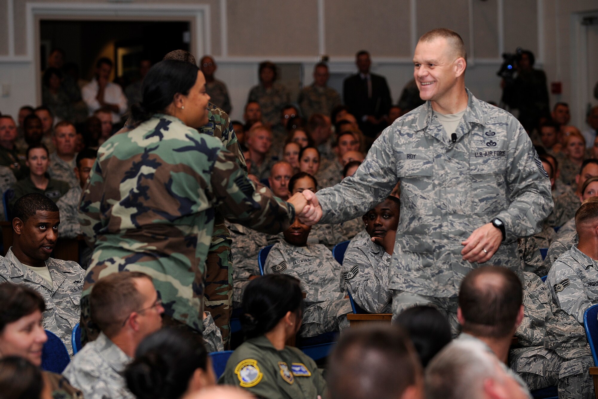 Chief Master Sgt. of the Air Force James Roy shakes hands with Tech. Sgt. Chamara Cantrell, 21st Dental Squadron, during a question and answer session Aug. 25 at the auditorium. Chief Roy spoke to a full house, addressing key focus areas such as training, base development, the 2009 Year of the Family, commitment to the Air Force community, and fulfilling Peterson’s warfighting mission. (Air Force photo by Craig Denton)