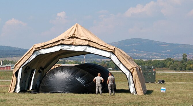 NIS, Serbia – Members of the 435th Contingency Response Group from Ramstein Air Base, Germany, wait for a large balloon to deflate under a morale tent in the military medical training exercise in Central and Europe, better known as MEDCEUR 2009, tent city Aug. 29. As the balloon inflated it lifted the tent ceiling, making the set up of the larger tent less challenging. (U.S. Air Force photo/Senior Airman Kali L. Gradishar)
