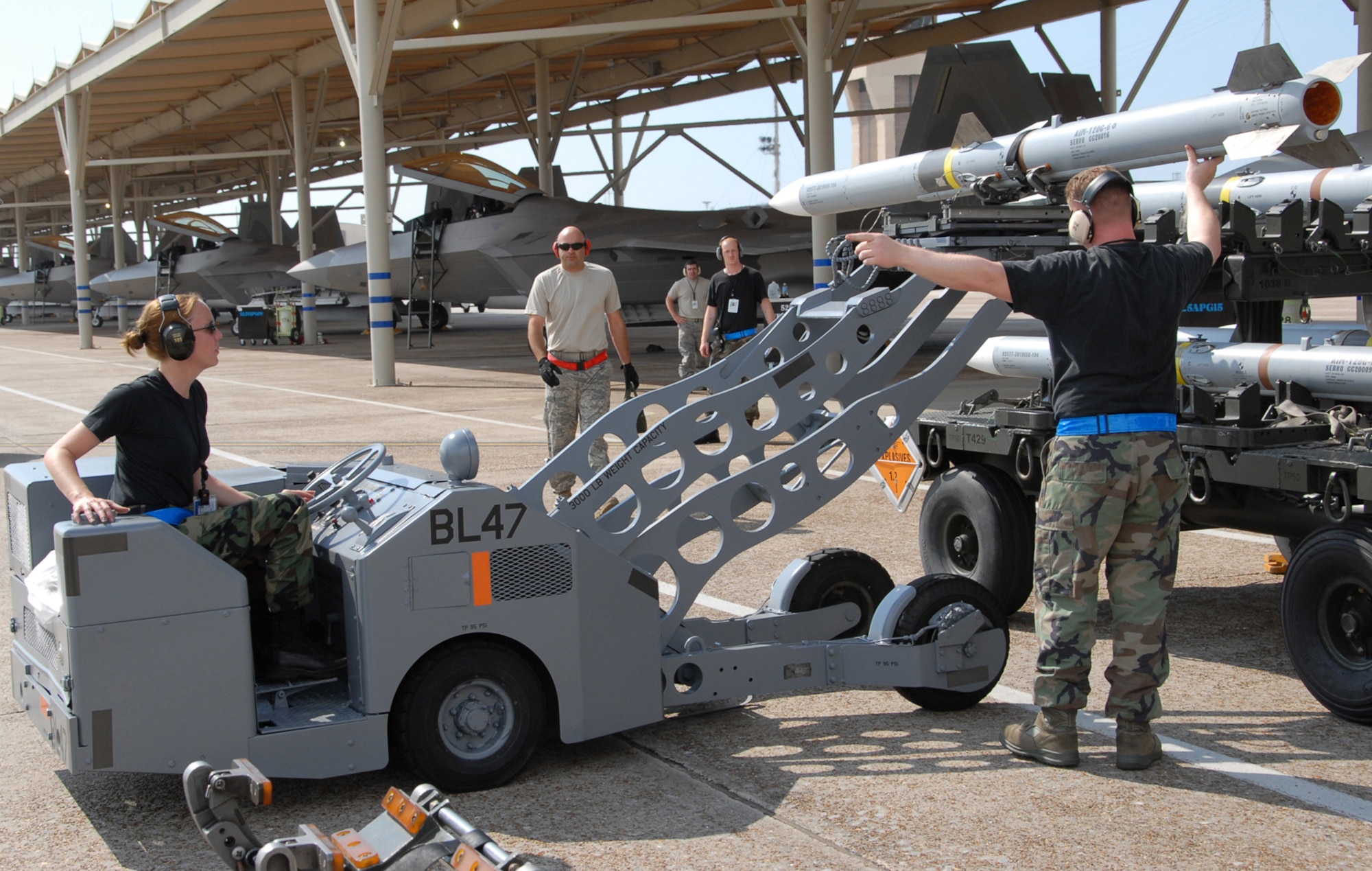 An MJ-1 bomb lift helps crew members load live munitions onto aircraft at Tyndall AFB, Fla., as part of the Weapons System Evaluation Program. The truck, similar to ones being overhauled by the 526th Electronics Maintenance Squadron, can lift up to 3,000 pounds to a height of 78 inches, using side fork adapters and extension lift arms for increased flexibility.