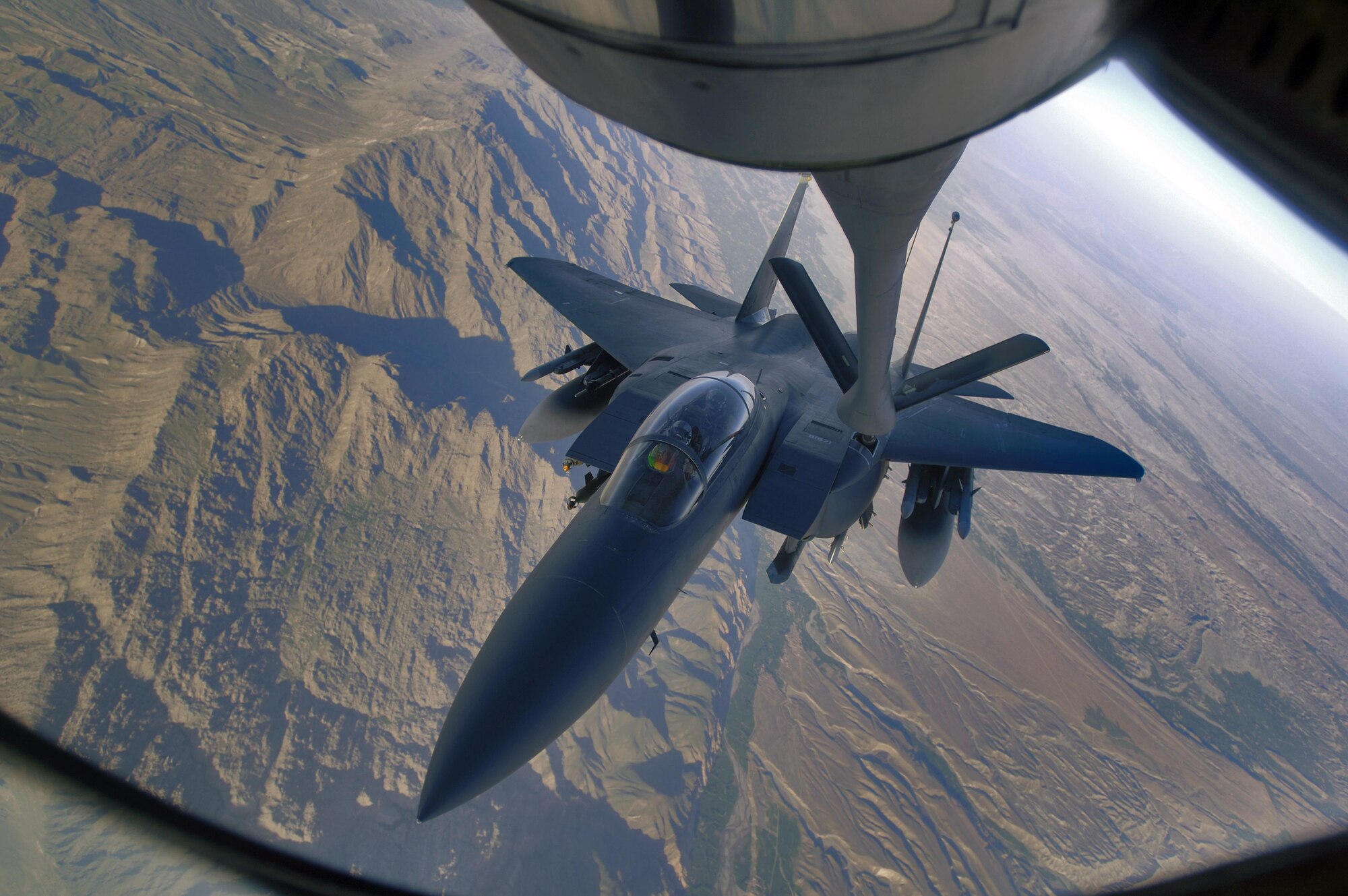 An F-15E Strike Eagle refuels over the mountains of Afghanistan April 12, 2006. The Strike Eagle is a dual-role fighter designed to perform air-to-air and air-to-ground missions. An array of avionics and electronics systems gives the F-15E the capability to fight at low altitude, day or night, and in all weather. (U.S. Air Force photo)  