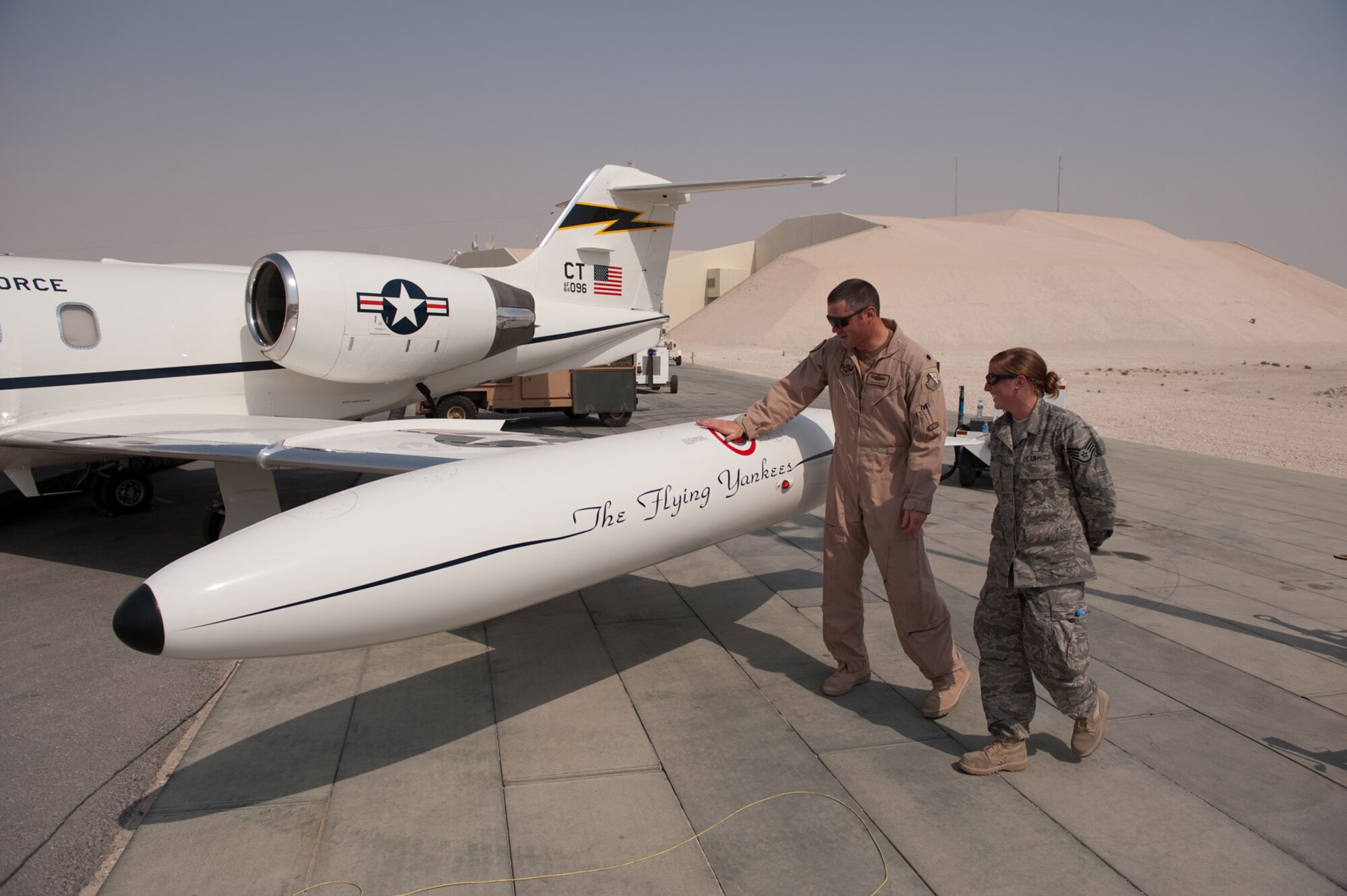 Left, Lt. Col. Kevin McManaman, 379th Expeditionary Operations Group C-21 pilot, and Staff Sgt. Michelle Urso, 379th Expeditionary Maintenance Squadron C-21 crew chief, conduct a final walkaround prior to a C-21 take-off,  Aug. 28, in Southwest Asia. The C-21 mission is to provide quick airlift capabilities for personnel and equipment throughout the U.S. Central Command area of responsibility. Both servicemembers are deployed from the Connecticut Air National Guard in support of Operations Iraqi and Enduring Freedom. (U.S. Air Force photo/Staff Sgt. Robert Barney)