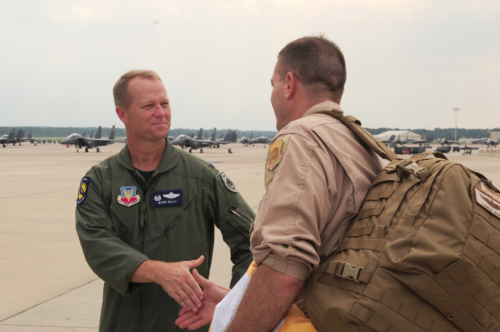 Col. Mark Kelly, 4th Fighter Wing commander, bids farewell to Lt. Col. Lance Bunch, 335th Fighter Squadron commander, and his Airmen before deploying from Seymour Johnson Air Force Base, N.C., Aug. 30, 2009. Colonel Kelly shook hands with all Airmen before they deployed to support Operation Enduring Freedom. (U.S. Air Force photo by Airman 1st Class Rae Perry)