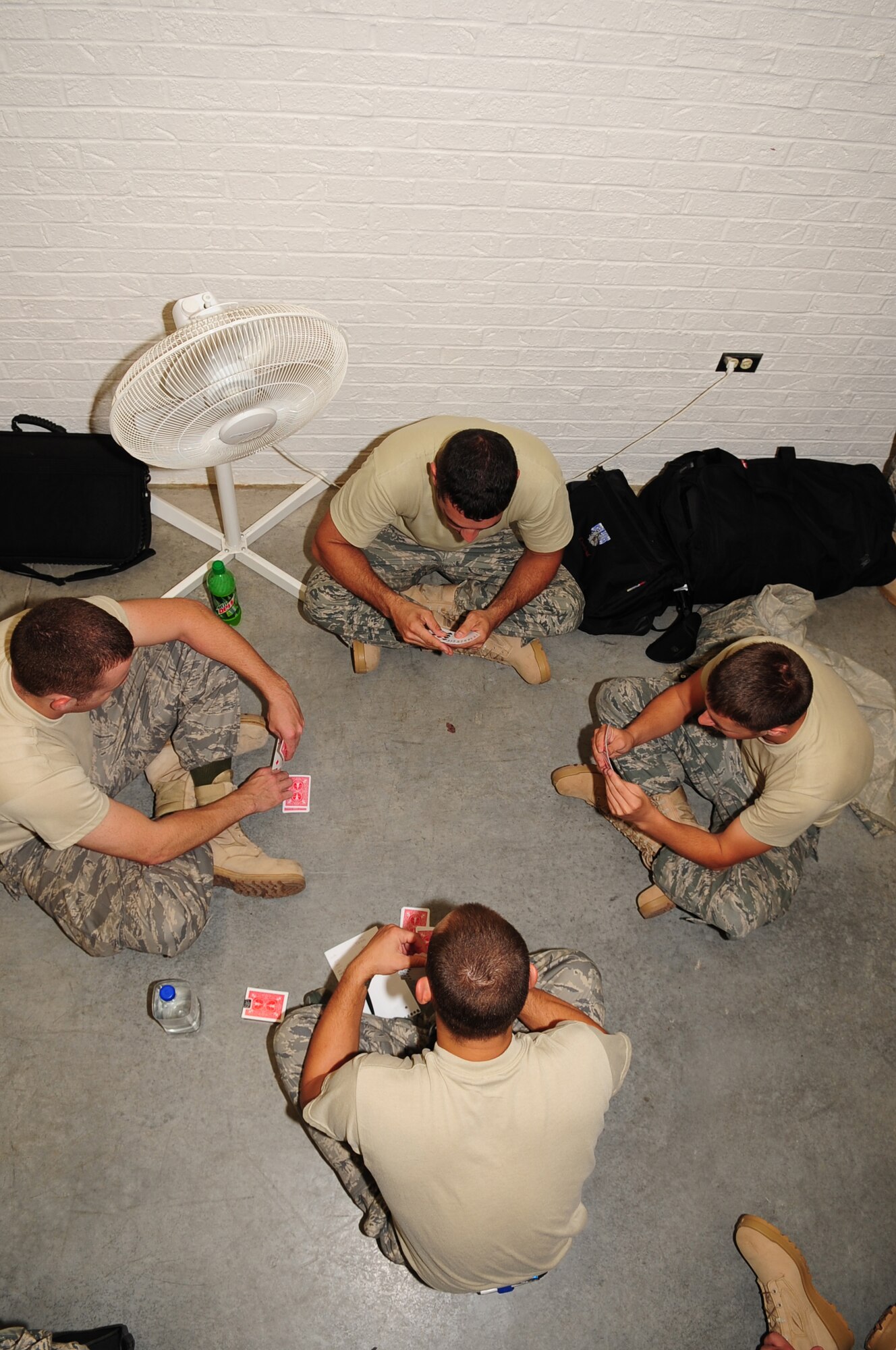 Airmen from the 335th Aircraft Maintenance Unit play a game of cards while waiting for deployment briefings at the Personnel Deployment Facility on Seymour Johnson Air Force Base, N.C., Aug. 30, 2009. The Airmen will replace members from the 336th Fighter Squadron and 336th Aircraft Maintenance Unit currently deployed to Afghanistan.  (U.S. Air Force photo by Airman 1st Class Rae Perry)