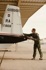Capt. Andrew Walker, Pilot Instructor Training student with the 84 FTS Laughlin Air Force Base, Texas, checks the functionality a T-6 Texan II control surfaces prior to a training flight involving formation flying, instrument flying, and acrobatics. (U.S. Air Force photo/Steve Thurow)
