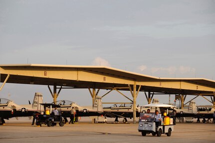 Crew Chiefs from the 12th Maintenance Squadron, Randolph Air Force Base Texas assemble at their assigned aircraft in preparation for the morning T-6 Texan II Pilot Instructor Training missions. (U.S. Air Force photo/Steve Thurow)