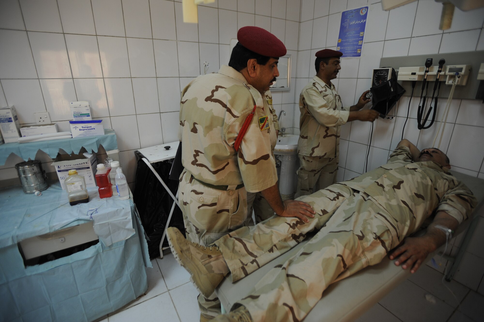 An Iraqi Army medical technician examines a fellow soldier Aug. 17, 2009 at Camp Ur, Iraq. (U.S. Air Force photo by Staff Sgt. Shawn Weismiller / Released)