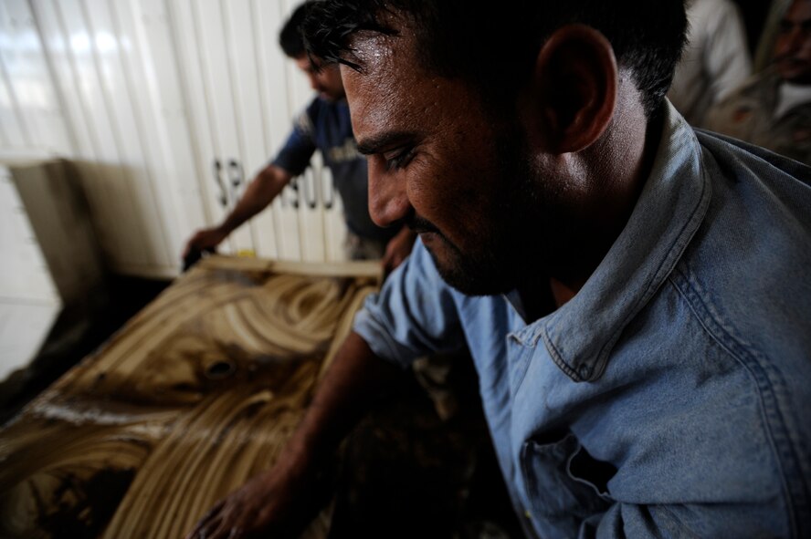 ALI BASE, Iraq - Iraqi contractors work on a generator that powers Camp Ur, an Iraqi military base, on the outskirts of An Nasariyah Aug. 17. (U.S. Air Force photo/Staff Sgt. Shawn Weismiller)