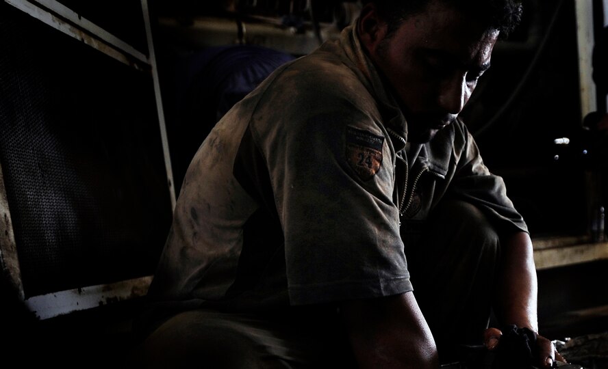ALI BASE, Iraq - An Iraqi contractor works on a generator that helps power Camp Ur, an Iraqi military base, near the city of An Nasiriyah Aug. 17. Camp Ur is supported by members of the Tallil Logistics Military Advisory Team who advise the Iraqis on base operations. (U.S. Air Force photo/Staff Sgt. Shawn Weismiller)