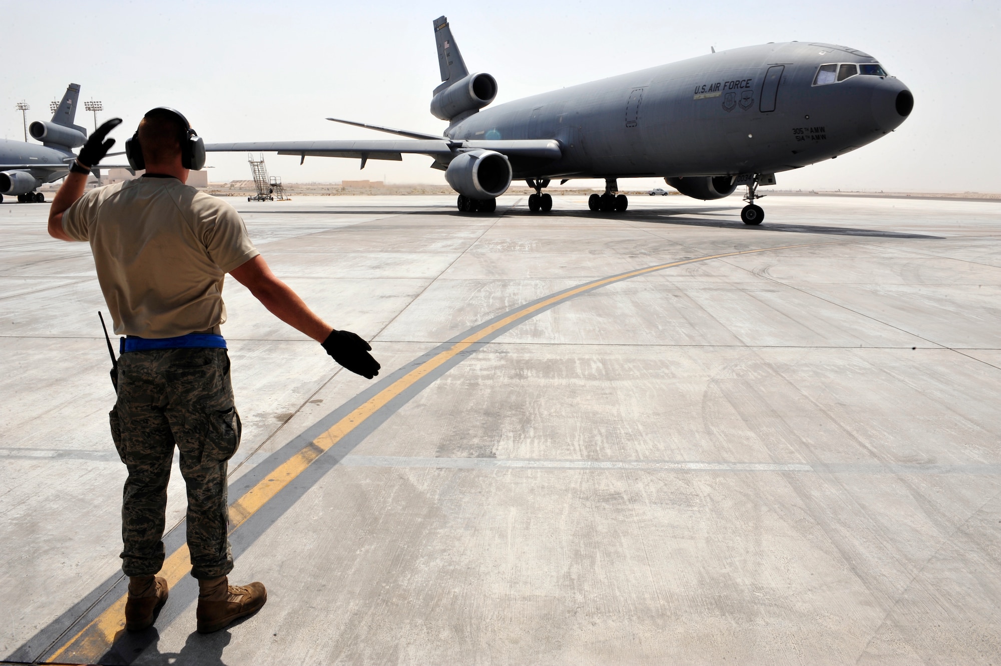 SOUTHWEST ASIA -Senior Airman Shawn Adams, 380th Expeditionary Maintenance
Squadron, marshals out a KC-10 Extender Aug. 29, 2009. Airman Adams is
deployed from Travis Air Force Base, Calif., and grew up in Wichita Falls,
Texas. (U.S. Air Force photo/Tech. Sgt. Charles Larkin Sr)