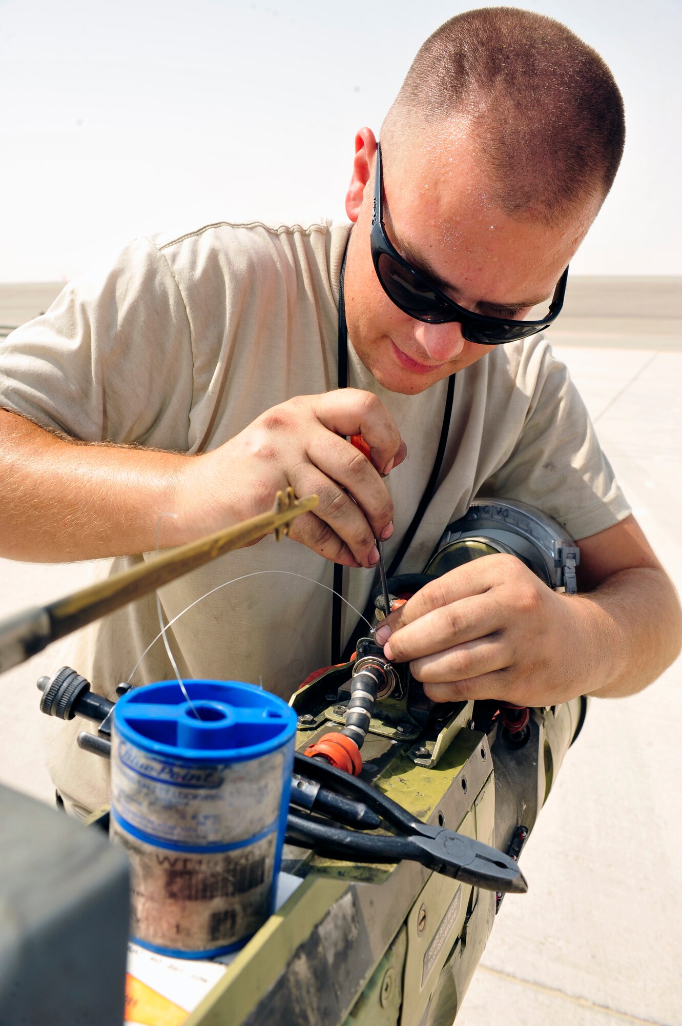 SOUTHWEST ASIA -Staff Sgt. Jason Swanson, 380th Expeditionary Maintenance
Squadron, safety wires a cannon plug on the boom of a KC-10 Extender Aug.
29, 2009. Sergeant Swanson is deployed from Travis Air Force Base, Calif.,
and grew up in Spokane, Wash. (U.S. Air Force photo/Tech. Sgt. Charles
Larkin Sr)