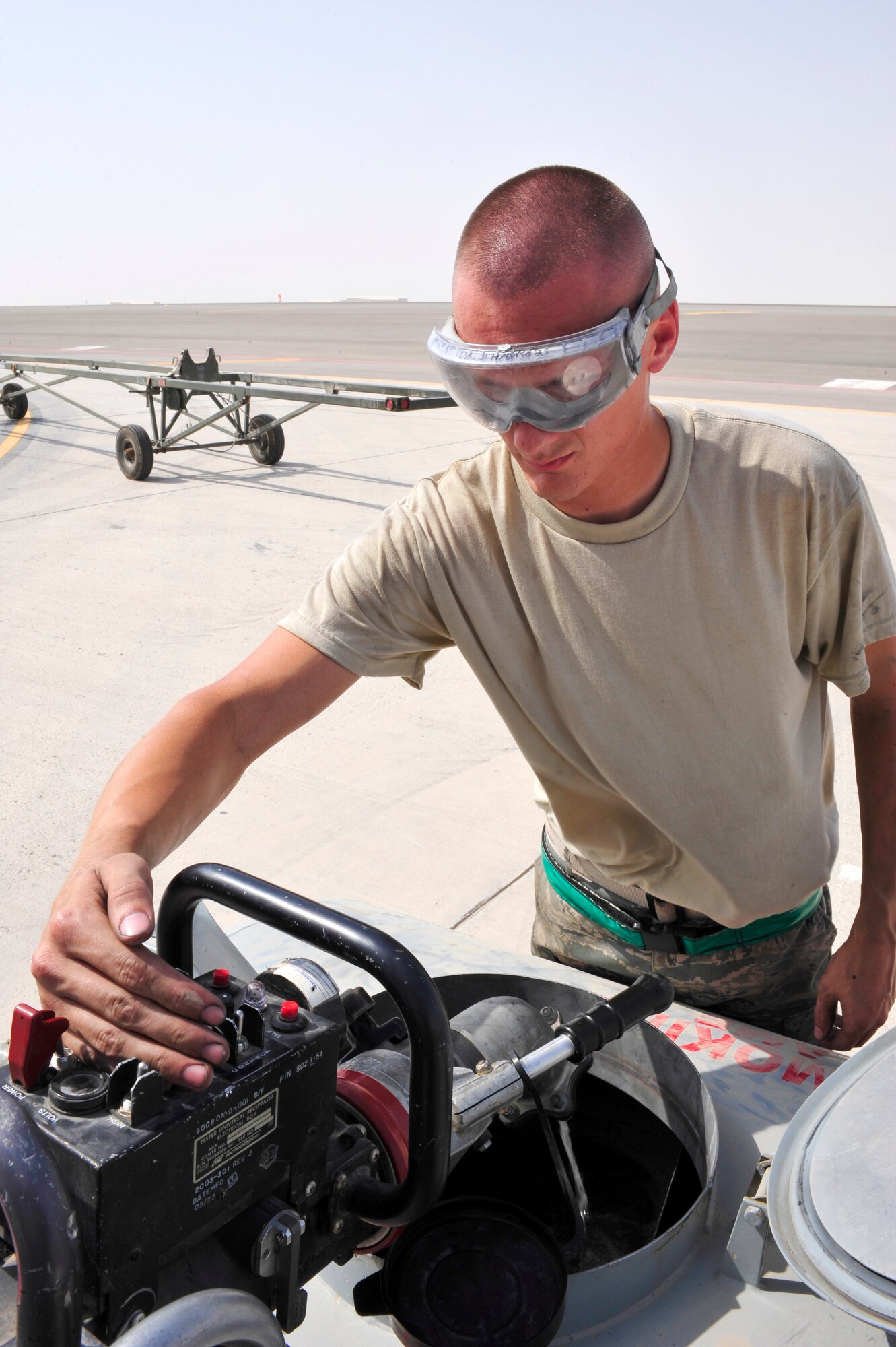 SOUTHWEST ASIA -Senior Airman Corey Keele, 380th Expeditionary Maintenance
Squadron, uses a single point refuel valve to drain the boom on a KC-10
Extender Aug. 29, 2009. Airman Keele is deployed from McGuire Air Force
Base, N.J., and grew up in Long View, Wash. (U.S. Air Force photo/Tech. Sgt.
Charles Larkin Sr)
