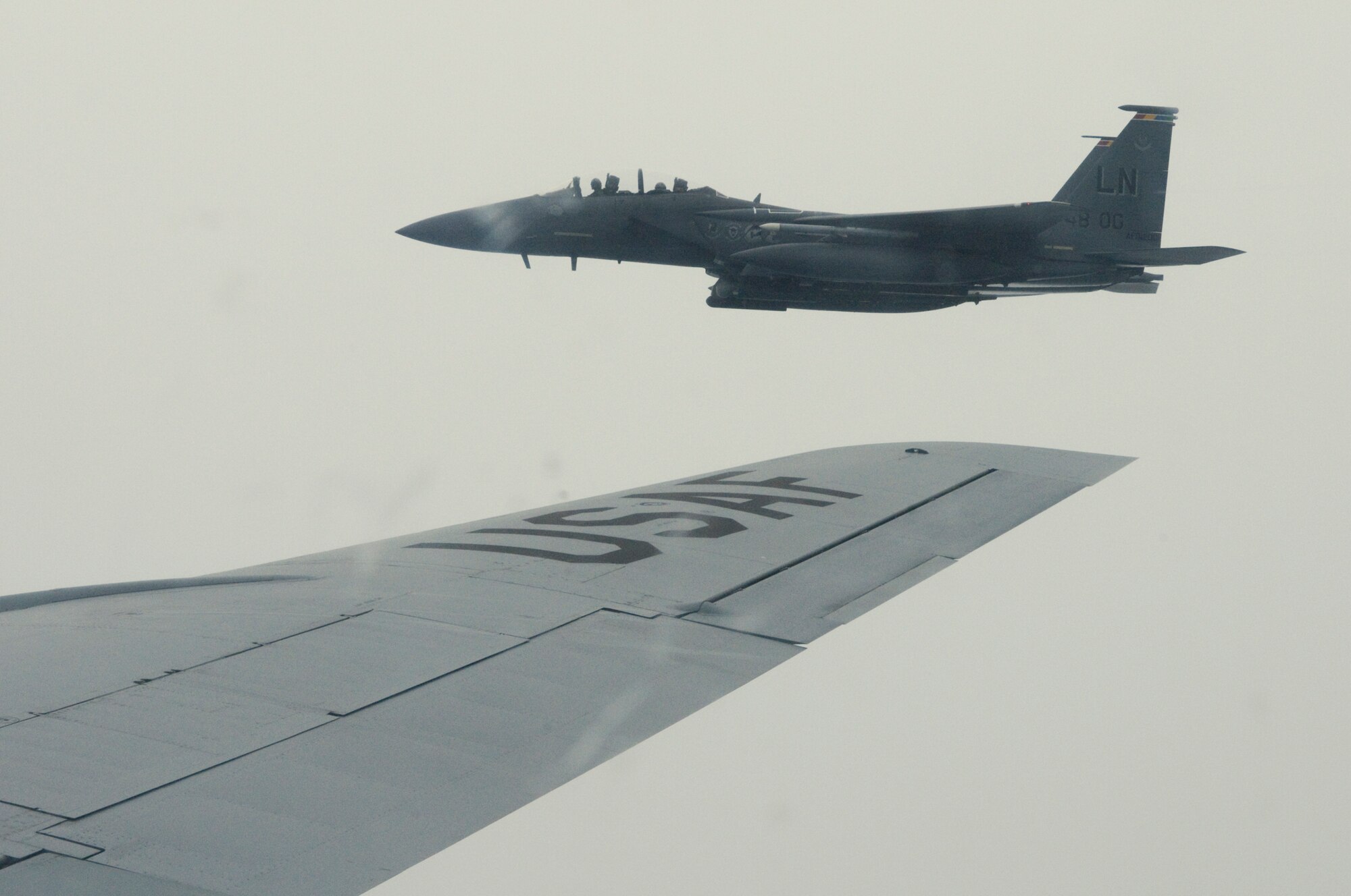 RAF MILDENHALL, England --  An RAF Lakenheath F-15E Strike Eagle assumes position after being refueled by an RAF Mildenhall KC-135 Stratotanker, Aug. 26. Being a Wingman is an Air Force concept the base shared with local community teachers that day, as the base hosted four educators and brought them aboard a community orientation flight. (US Air Force photo/Tech. Sgt. Kevin Wallace)