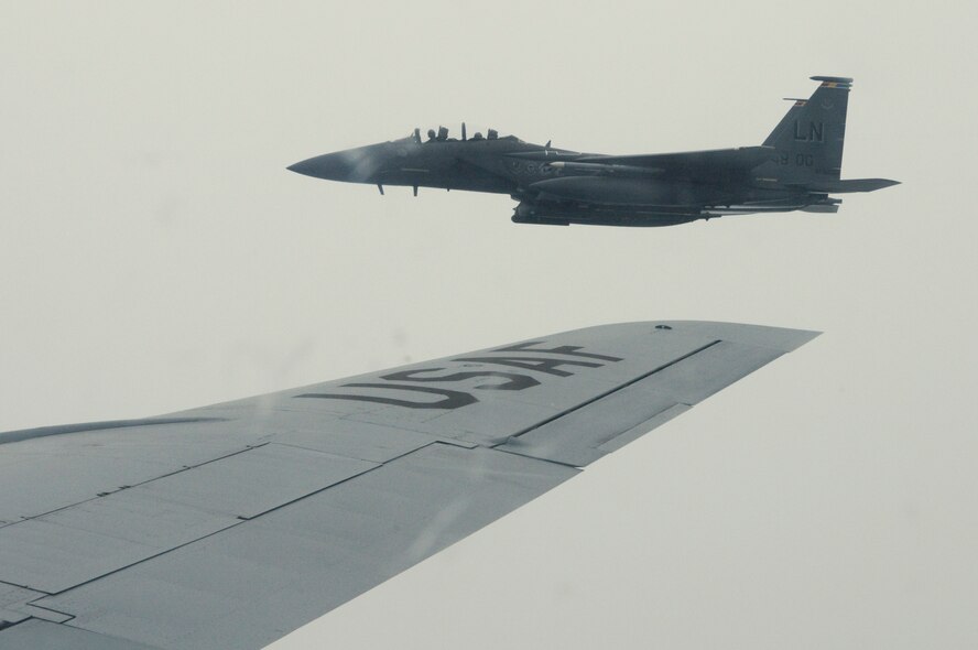 RAF MILDENHALL, England --  An RAF Lakenheath F-15E Strike Eagle assumes position after being refueled by an RAF Mildenhall KC-135 Stratotanker, Aug. 26. Being a Wingman is an Air Force concept the base shared with local community teachers that day, as the base hosted four educators and brought them aboard a community orientation flight. (US Air Force photo/Tech. Sgt. Kevin Wallace)