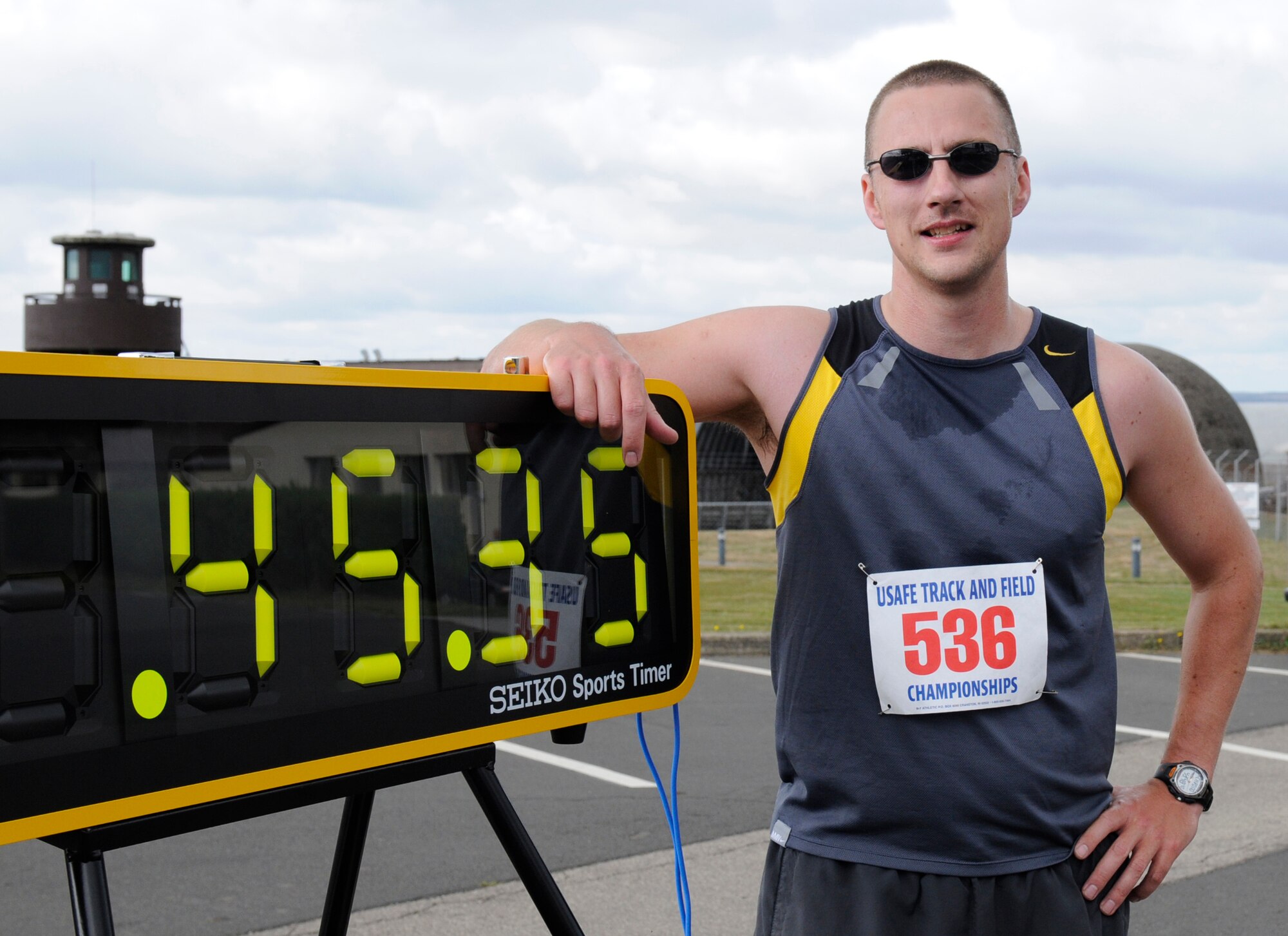 SPANGDAHLEM AIR BASE, Germany – Staff Sgt Brent Murphy, 52nd Equipment Maintenance Squadron, poses for a photo seconds after his 43 minute 38 second first place 10 kilometer finish. Sergeant Murphy competed in the run Aug. 29 around the perimeter running path on Spangdahlem organized by the fitness center staff. (U.S. Air Force photo/Master Sgt Bill Gomez)